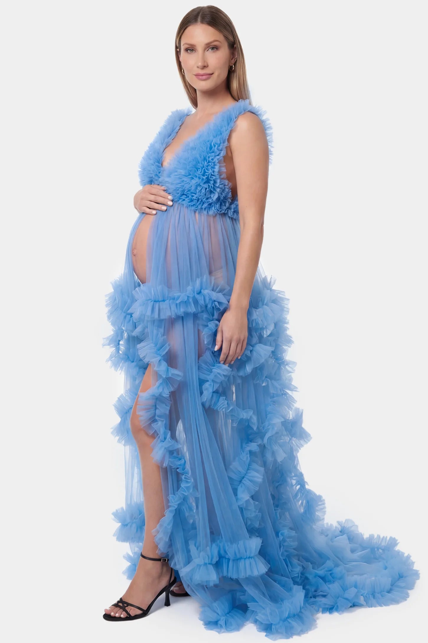 Multi-Layered Tulle Deep V-Neck Sleeveless Maxi Maternity Gown Multi-layered tulle deep V-neck sleeveless maxi maternity gown in blue featuring flowing pleated silhouette in full body side view on a pregnant model