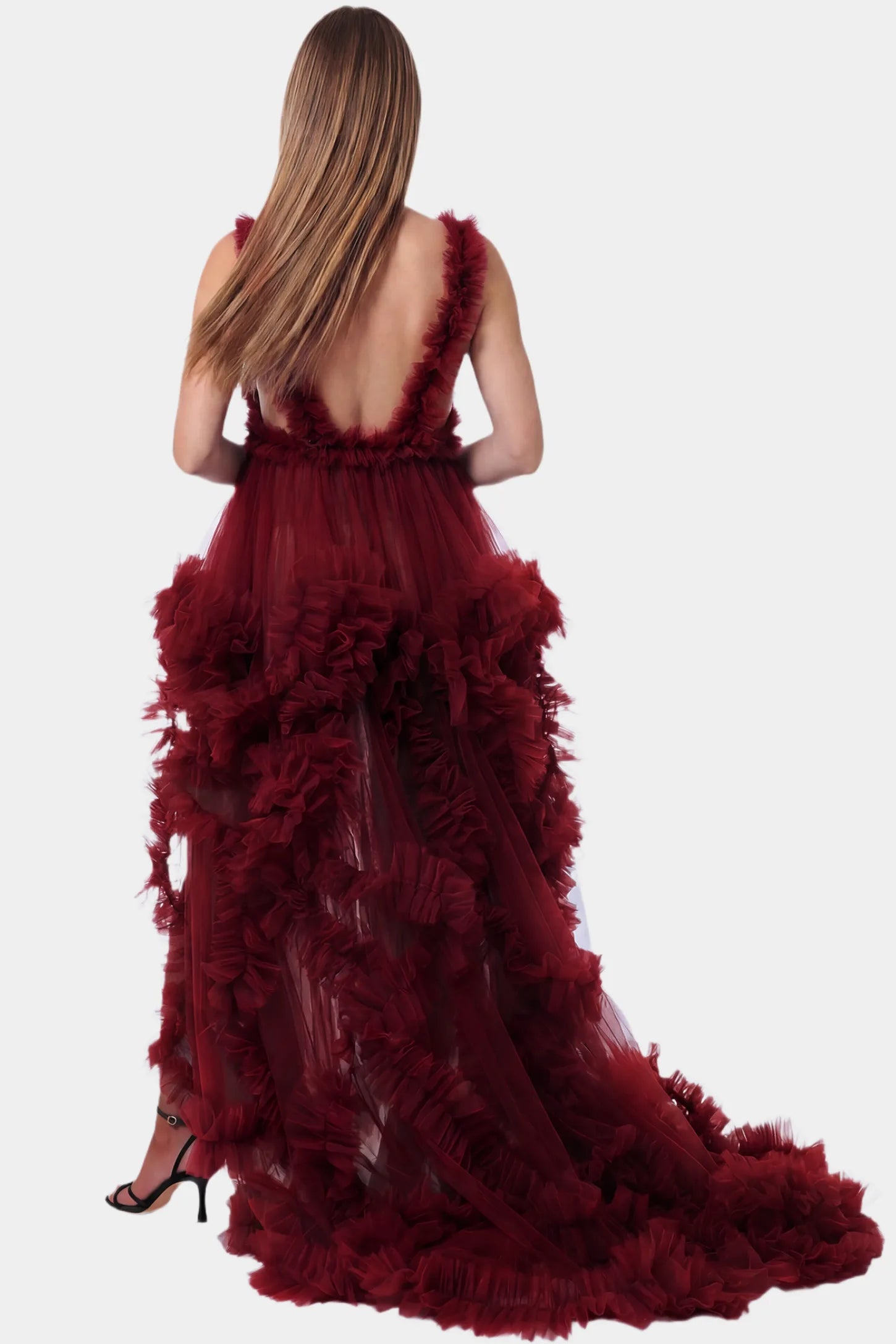 Multi-Layered Tulle Deep V-Neck Sleeveless Maxi Maternity Gown Multi-layered tulle deep V-neck sleeveless maxi maternity gown in burgundy featuring an open back in full body front view on a pregnant model