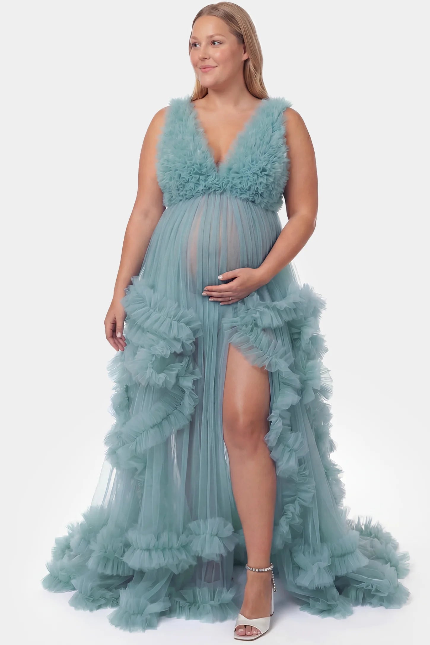 Multi-Layered Tulle Deep V-Neck Sleeveless Maxi Maternity Gown Multi-layered tulle deep V-neck sleeveless maxi maternity gown in lake blue featuring flowing pleated silhouette in full body front view on a plus-size model