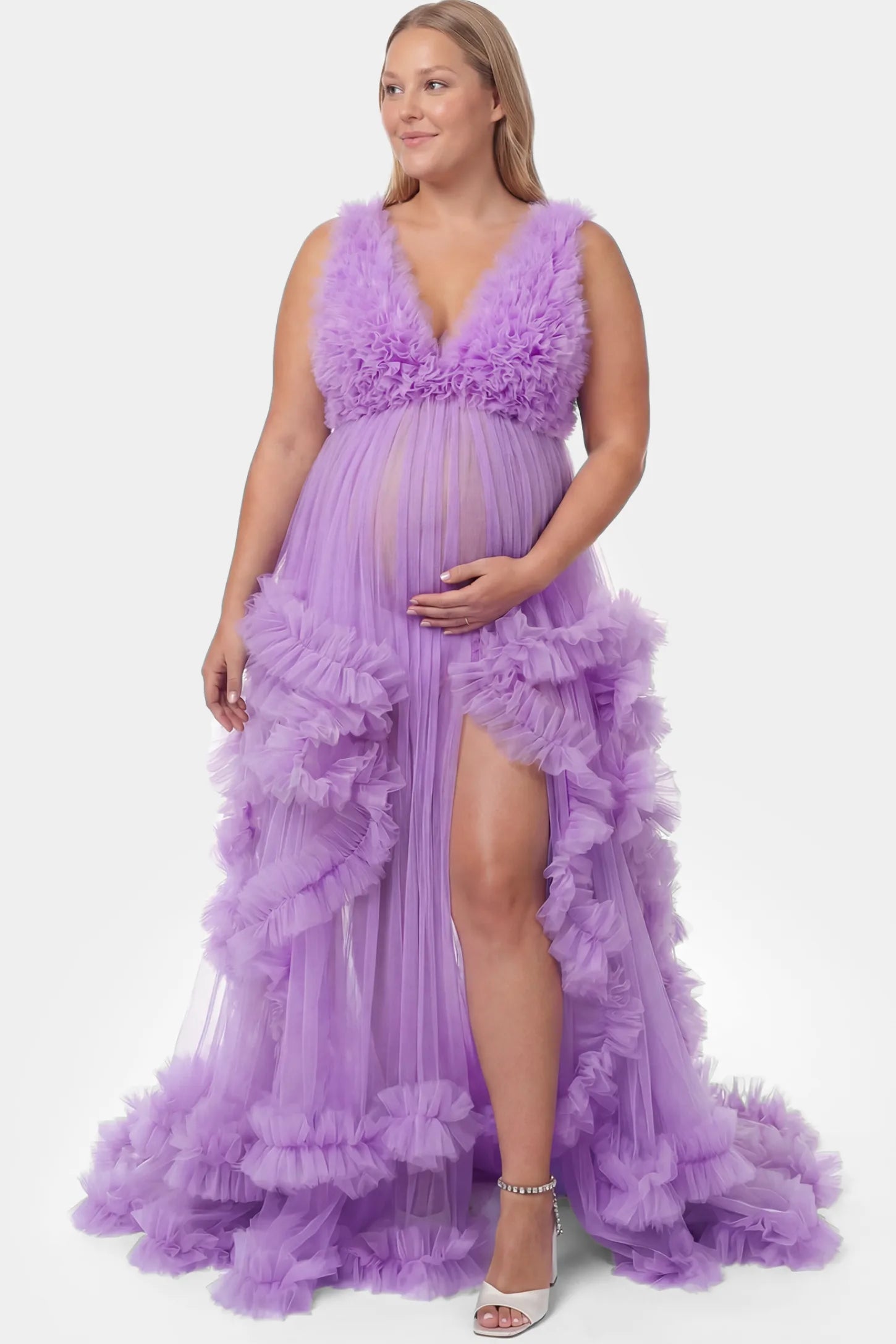 Multi-Layered Tulle Deep V-Neck Sleeveless Maxi Maternity Gown Multi-layered tulle deep V-neck sleeveless maxi maternity gown in lavender featuring flowing pleated silhouette in full body front view on a plus-size model
