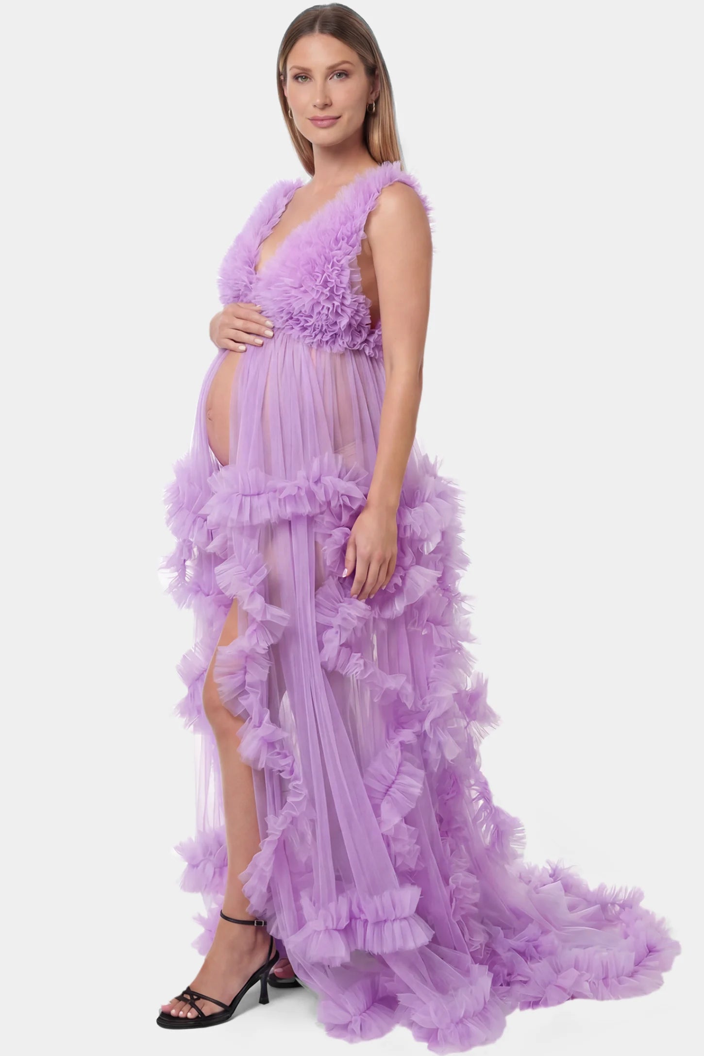 Multi-Layered Tulle Deep V-Neck Sleeveless Maxi Maternity Gown Multi-layered tulle deep V-neck sleeveless maxi maternity gown in lavender featuring flowing pleated silhouette in full body side view on a pregnant model
