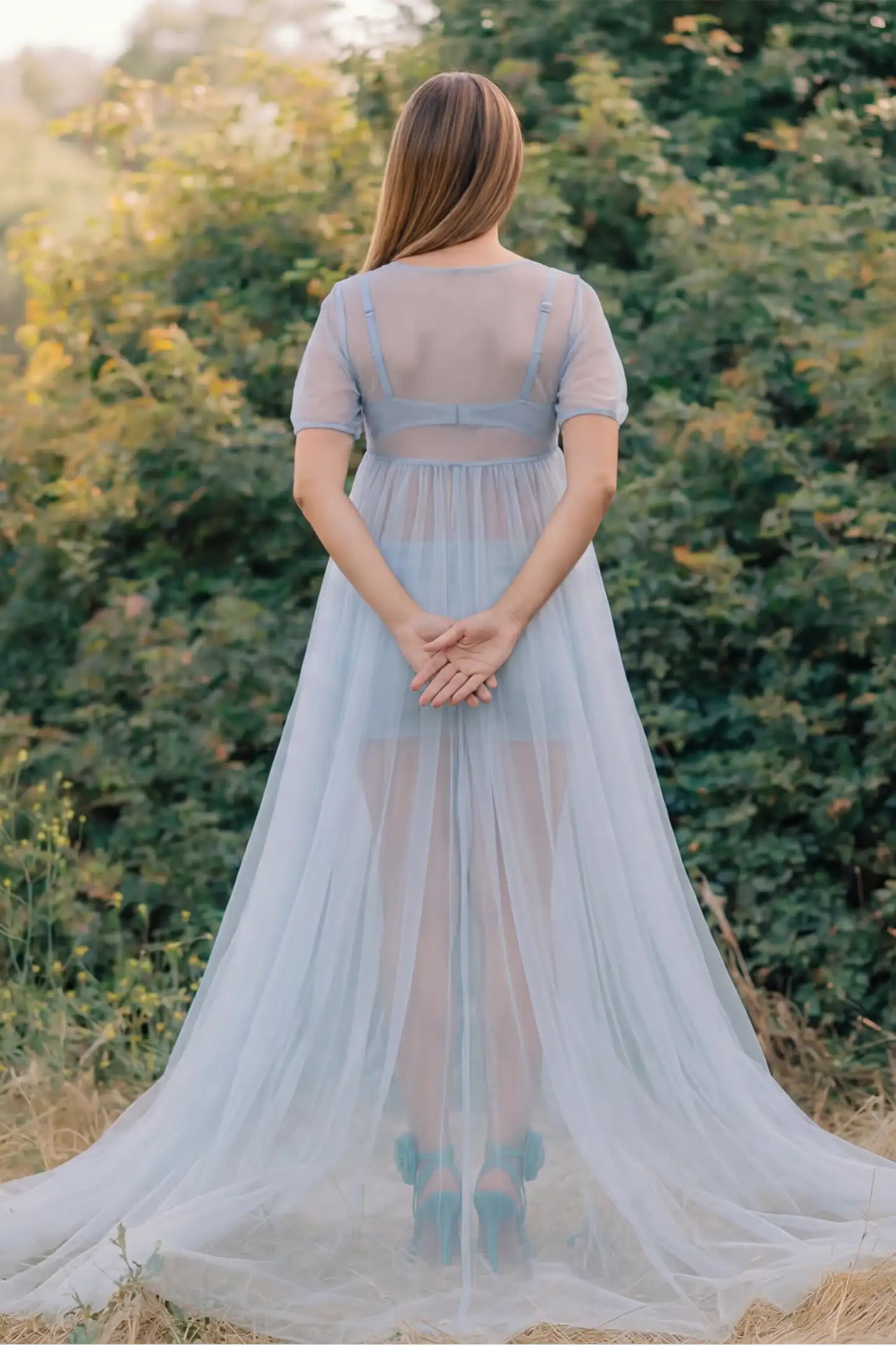 Tulle-Lace Sheer Half Sleeve Maternity Photoshoot Gown Tulle-lace sheer half sleeve maternity gown in light blue with airy sheer sleeves, back view on pregnant model