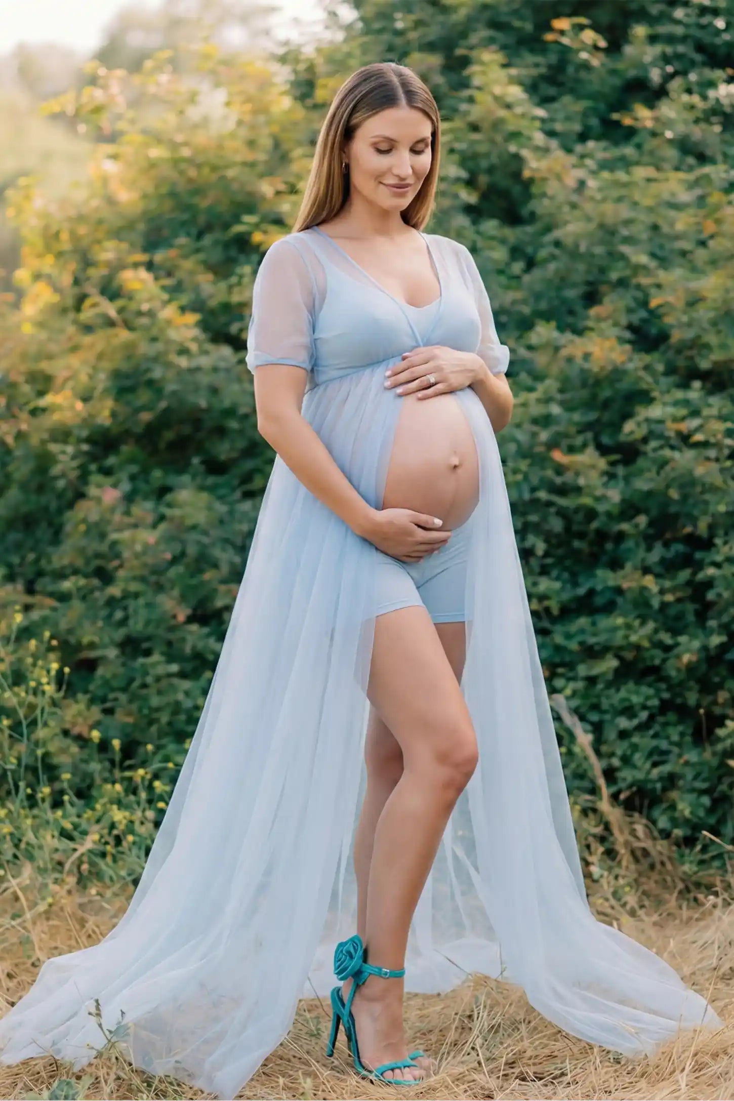 Tulle-Lace Sheer Half Sleeve Maternity Photoshoot Gown Tulle-lace sheer half sleeve maternity gown in light blue with delicate lace-spliced detail and high front slit, front view on pregnant model