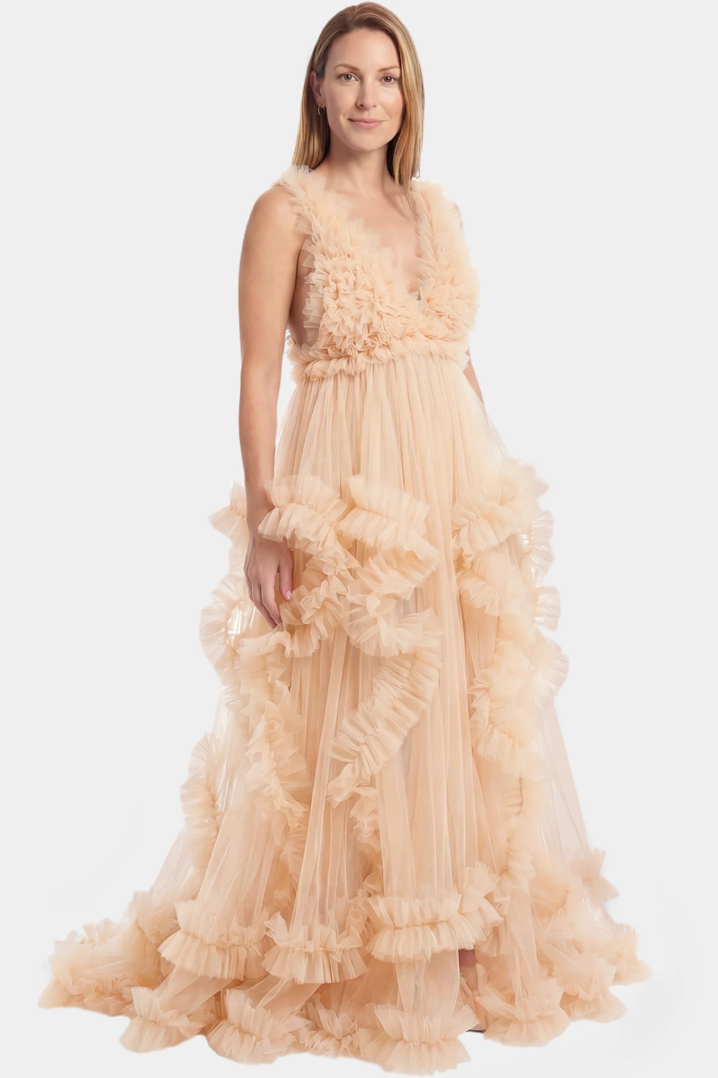 Multi-Layered Tulle Deep V-Neck Sleeveless Maxi Maternity Gown Multi-layered tulle deep V-neck sleeveless maxi maternity gown in nude featuring flowing pleated silhouette in full body front view on a postpartum model
