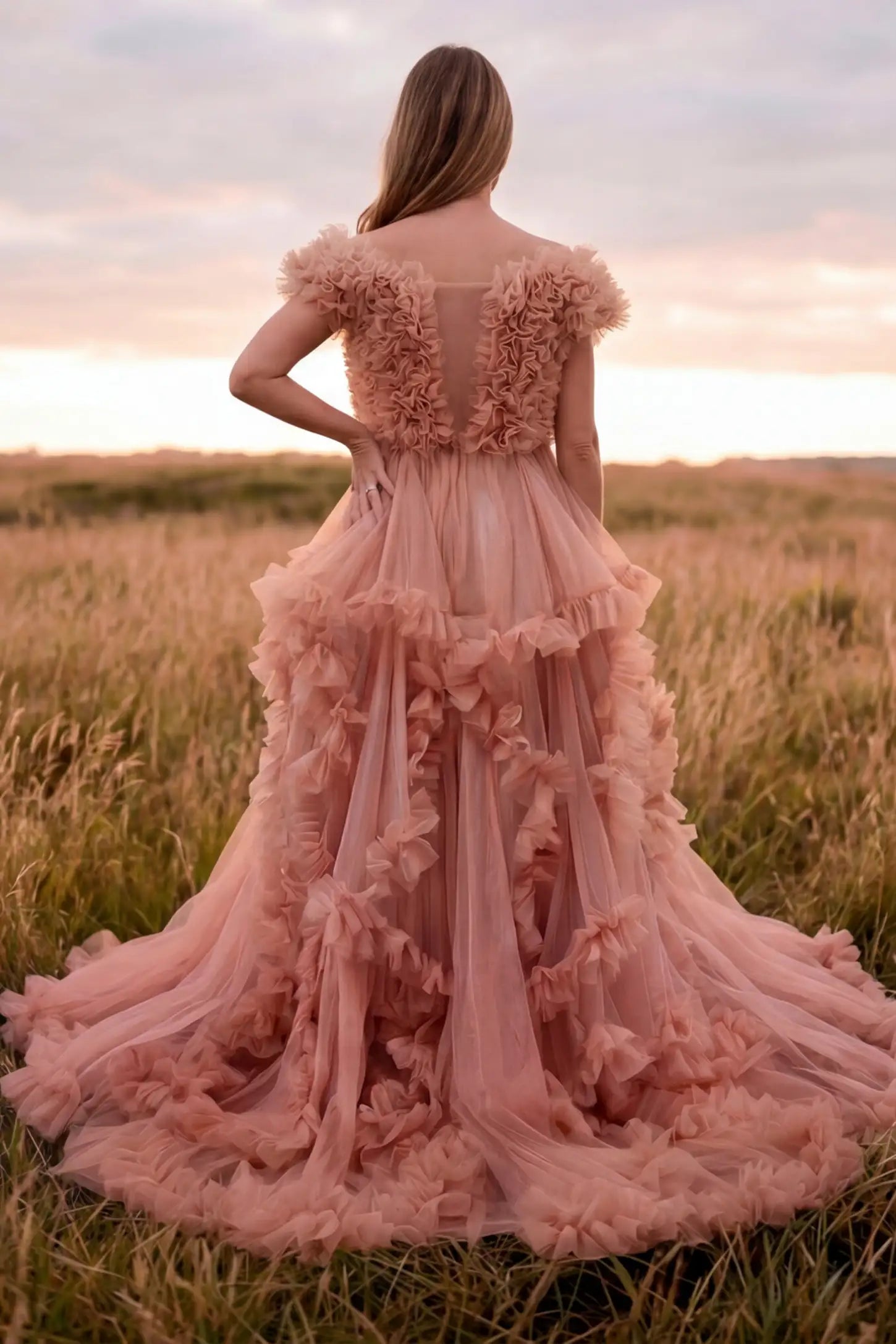 Ruffled Tulle Convertible Neckline Maternity Photoshoot Gown Ruffled tulle convertible neckline maternity photoshoot gown in pink with ruffled tulle layers, back view on pregnant model