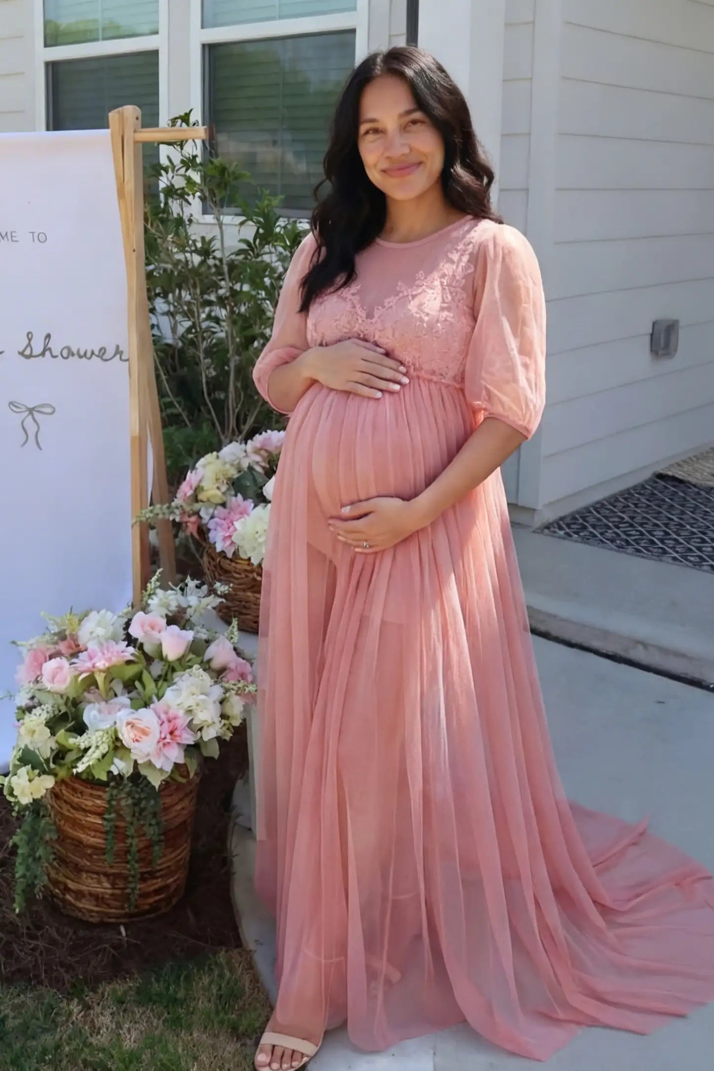 Tulle-Lace V-Neck Short Sleeve Trailing Maxi Maternity Dress Tulle-lace V-neck short sleeve trailing maxi maternity dress in pink with layered tulle skirt, full body on editorial lifestyle model