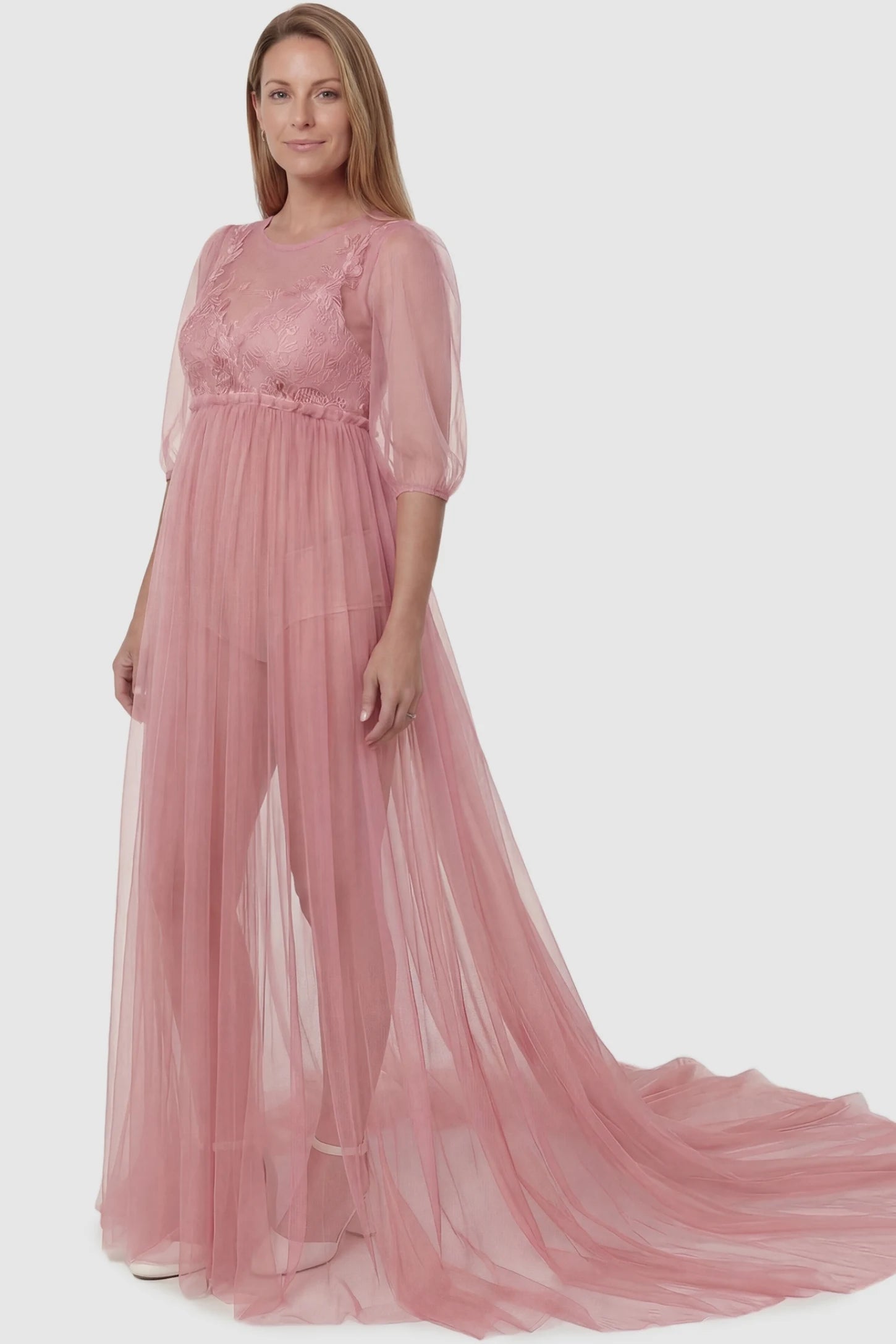 Tulle-Lace V-Neck Short Sleeve Trailing Maxi Maternity Dress Tulle-lace V-neck short sleeve trailing maxi maternity dress in pink featuring romantic photography silhouette in full body view on a postpartum model