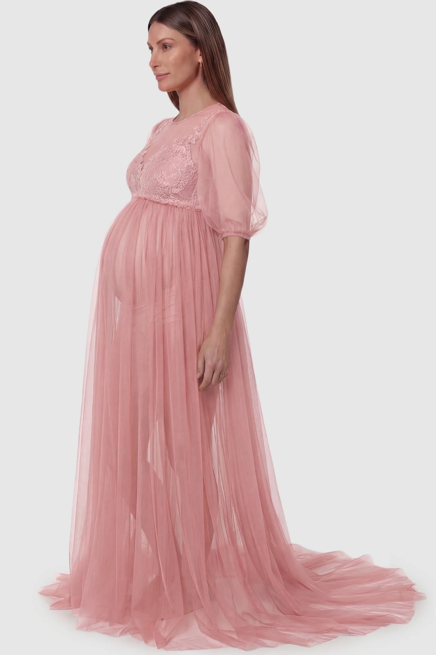 Tulle-Lace V-Neck Short Sleeve Trailing Maxi Maternity Dress Tulle-lace V-neck short sleeve trailing maxi maternity dress in pink featuring flowing layered tulle skirt in side view on a pregnant model