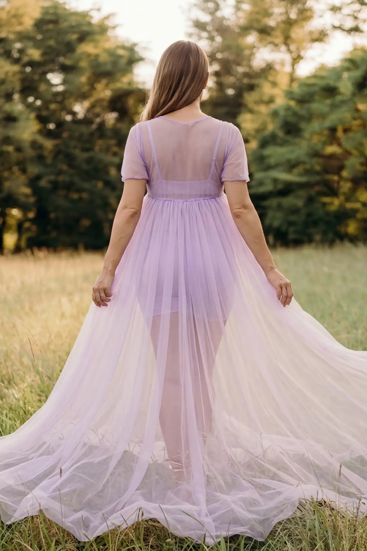 Tulle-Lace Sheer Half Sleeve Maternity Photoshoot Gown Tulle-lace sheer half sleeve maternity gown in violet with airy sheer sleeves, back view on pregnant model