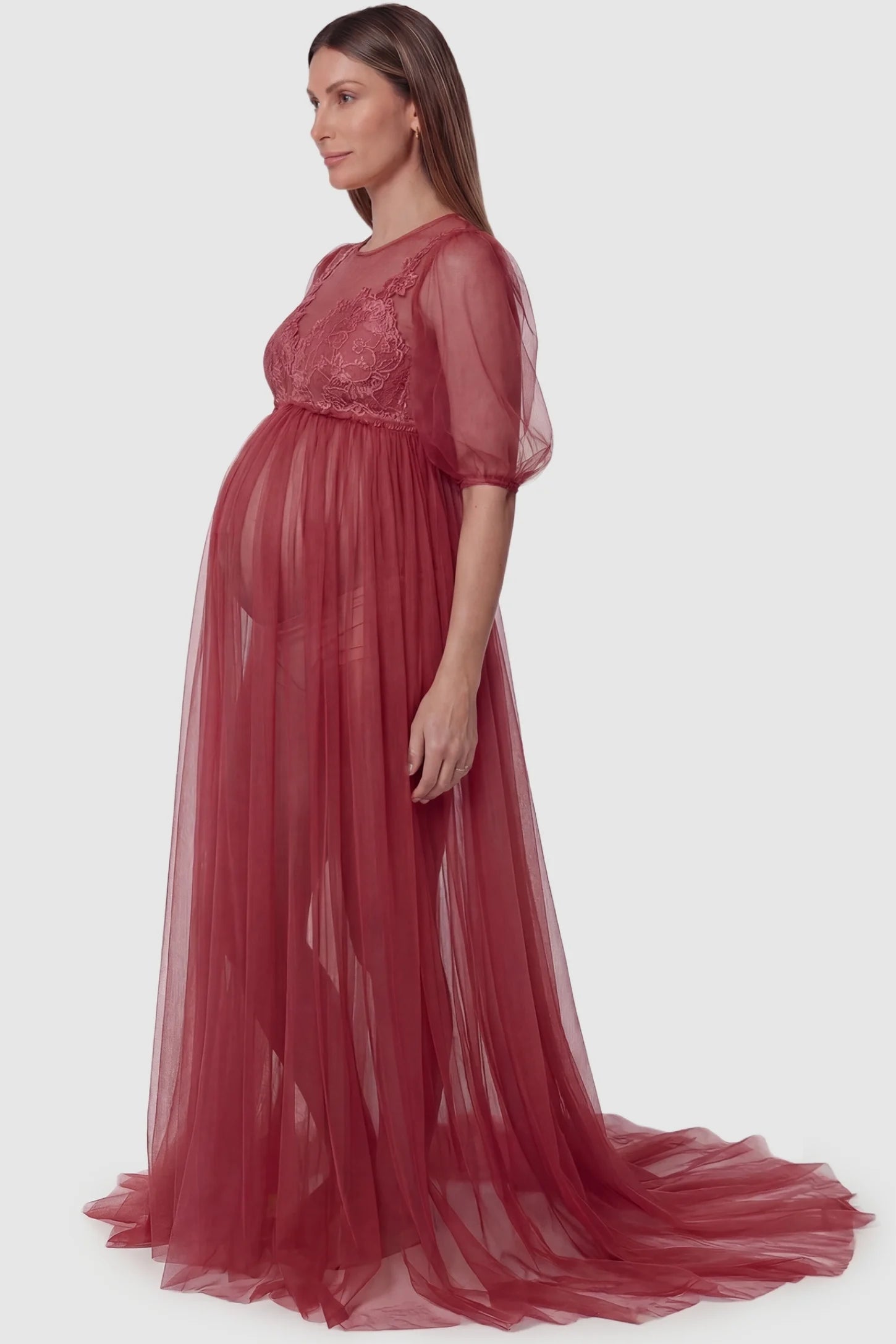 Tulle-lace V-neck short sleeve trailing maxi maternity dress in wine red featuring flowing layered tulle skirt in side view on a pregnant model