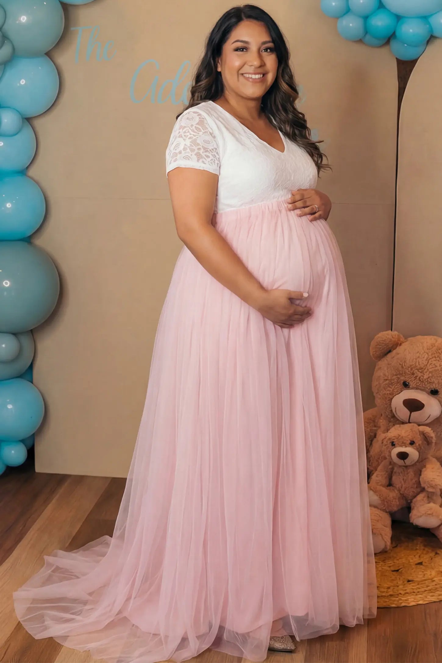 Lace & Tulle Short Sleeve Maternity Gown in pink featuring V-neck lace bodice, empire waist, and flowing tulle train on pregnant model.