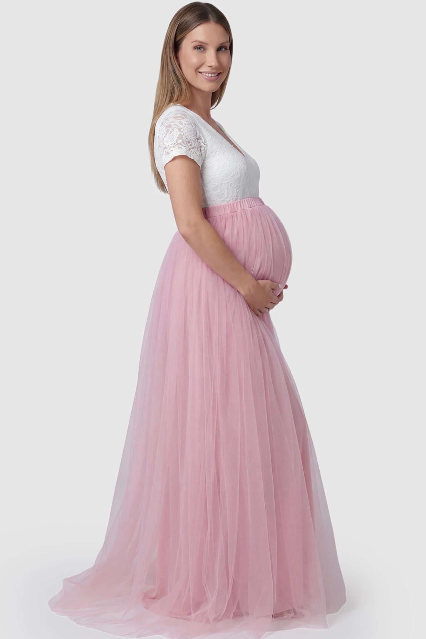 Lace & Tulle Short Sleeve Maternity Gown Lace & Tulle Short Sleeve Maternity Gown in pink featuring lace bodice, empire waist, and flowing tulle train on pregnant model.