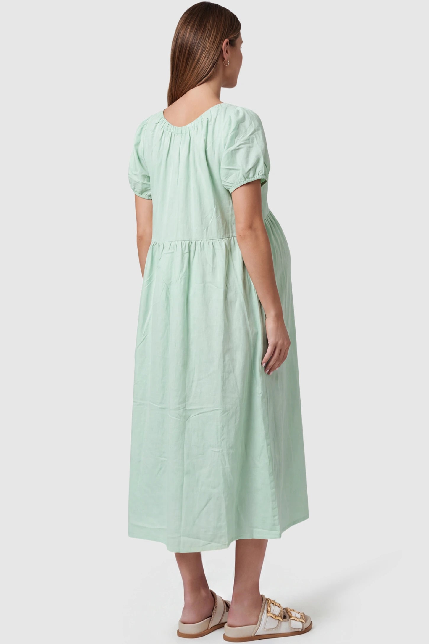 V-Neck Short Sleeve Maternity Midi Dress with Pockets V-neck short sleeve maternity midi dress with pockets in green with short sleeves, back view on pregnant model