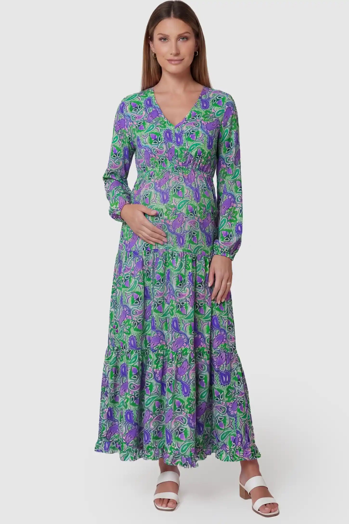Paisley Print V-Neck Tiered Maternity Maxi Dress in green paisley pattern featuring empire waist and flowy tiered skirt on pregnant model.