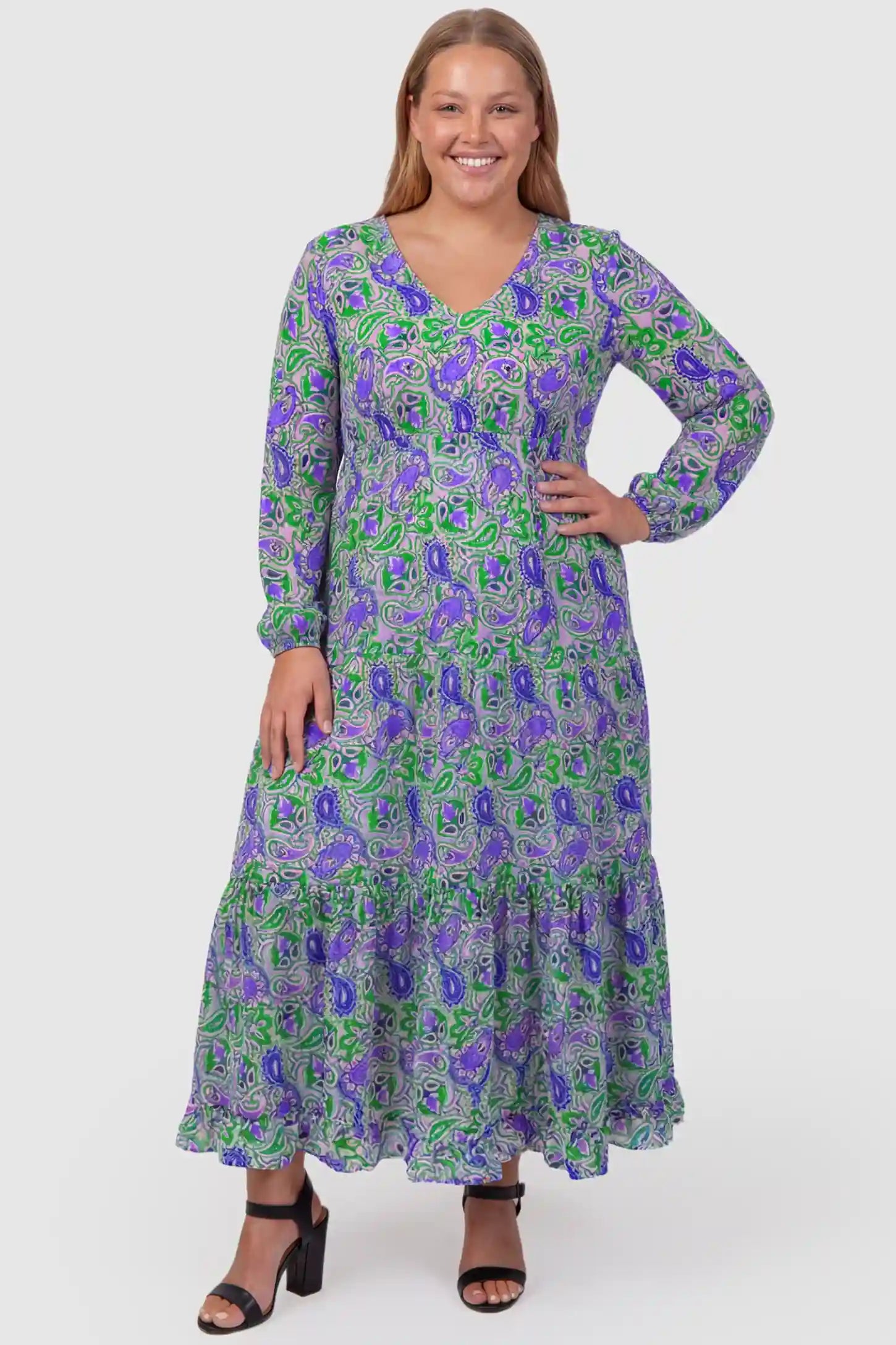 Paisley Print V-Neck Tiered Maternity Maxi Dress Paisley Print V-Neck Tiered Maternity Maxi Dress in green paisley pattern featuring empire waist and flowy tiered skirt on plus size pregnant model.