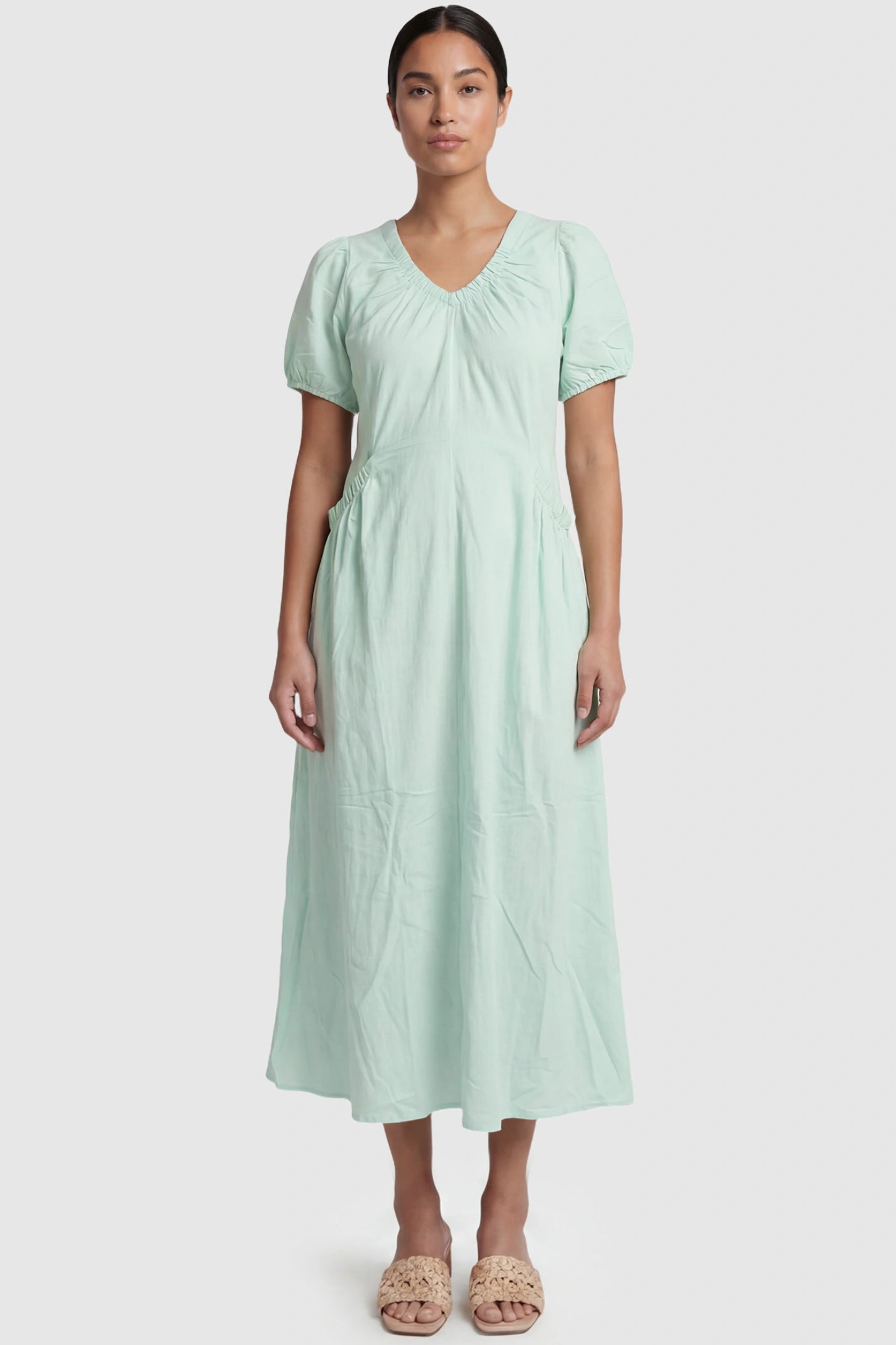 V-Neck Short Sleeve Maternity Midi Dress with Pockets V-neck short sleeve maternity midi dress with pockets in green with V-neckline detail, front view on postpartum model