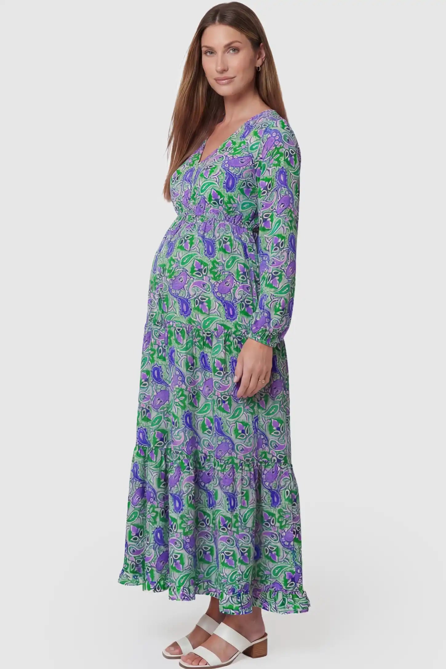 Paisley Print V-Neck Tiered Maternity Maxi Dress Paisley Print V-Neck Tiered Maternity Maxi Dress in green paisley pattern featuring empire waist and flowy tiered skirt on pregnant model.