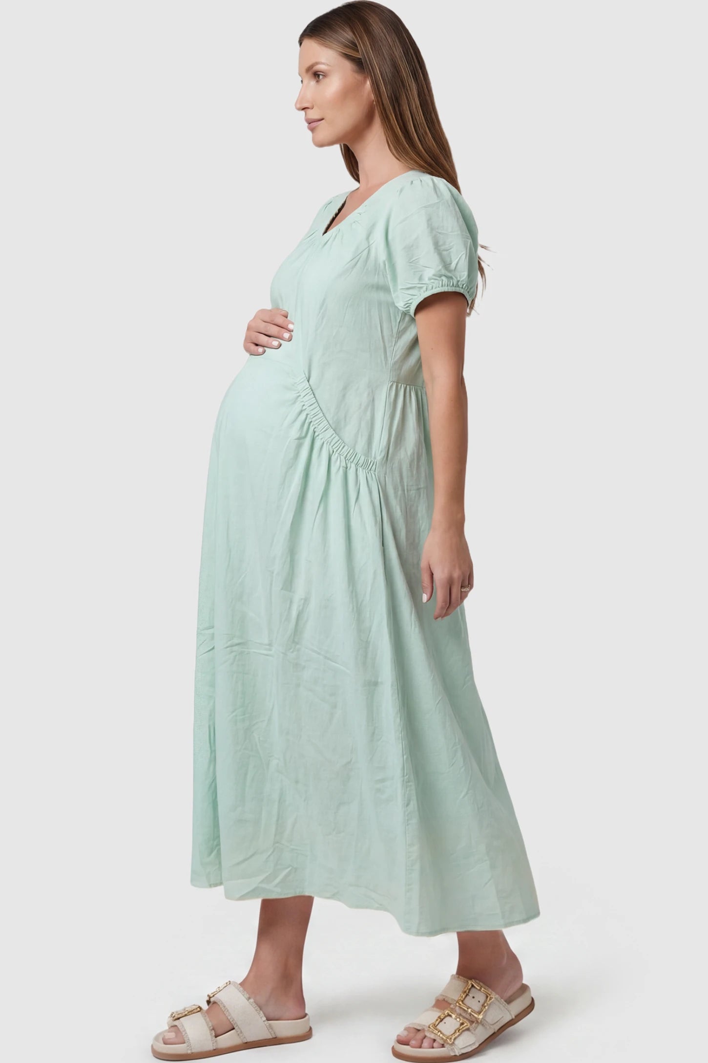 V-Neck Short Sleeve Maternity Midi Dress with Pockets V-neck short sleeve maternity midi dress with pockets in green with practical side pockets, side view on pregnant model