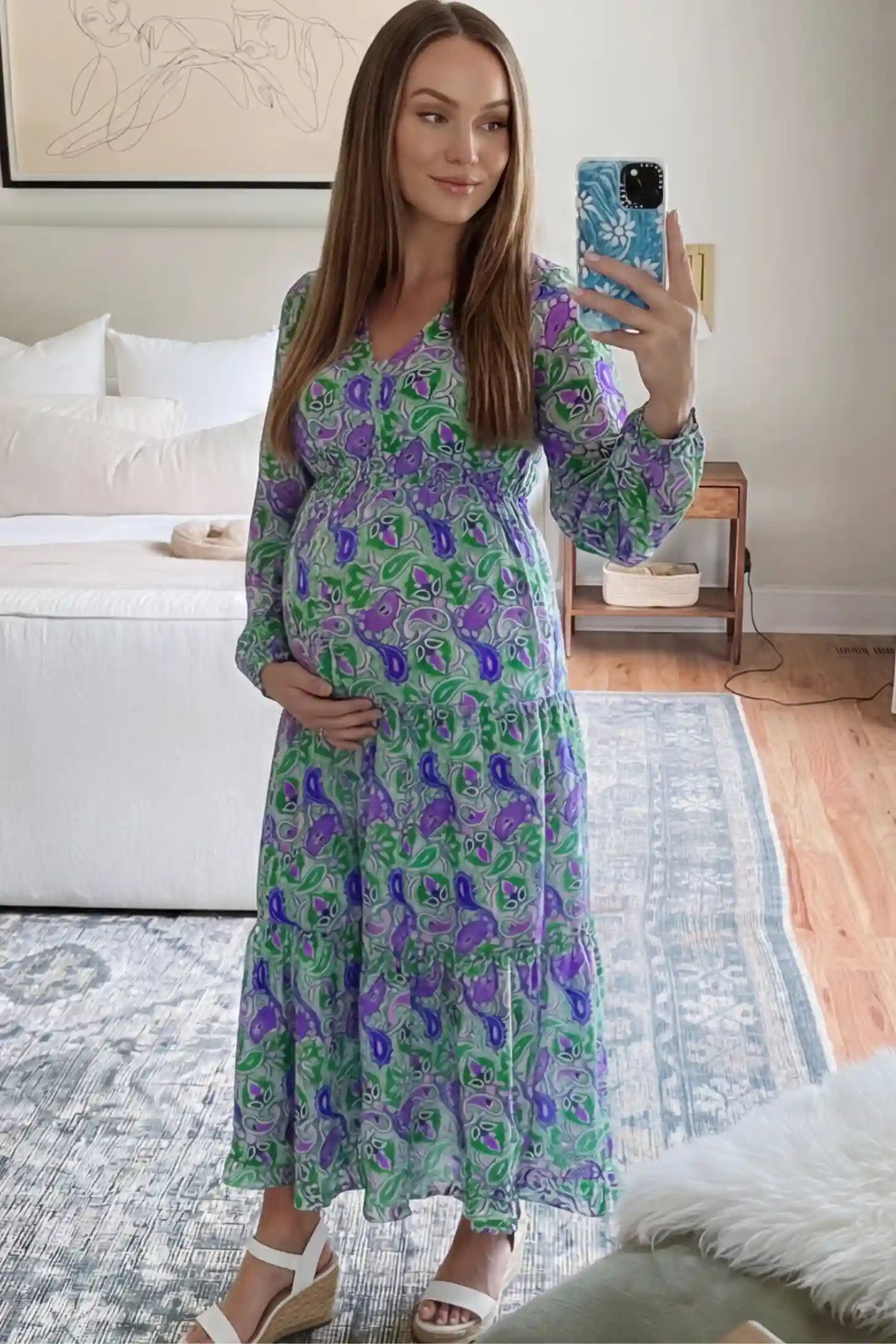 Paisley Print V-Neck Tiered Maternity Maxi Dress Paisley Print V-Neck Tiered Maternity Maxi Dress in green paisley pattern featuring empire waist and flowy tiered skirt on pregnant model.