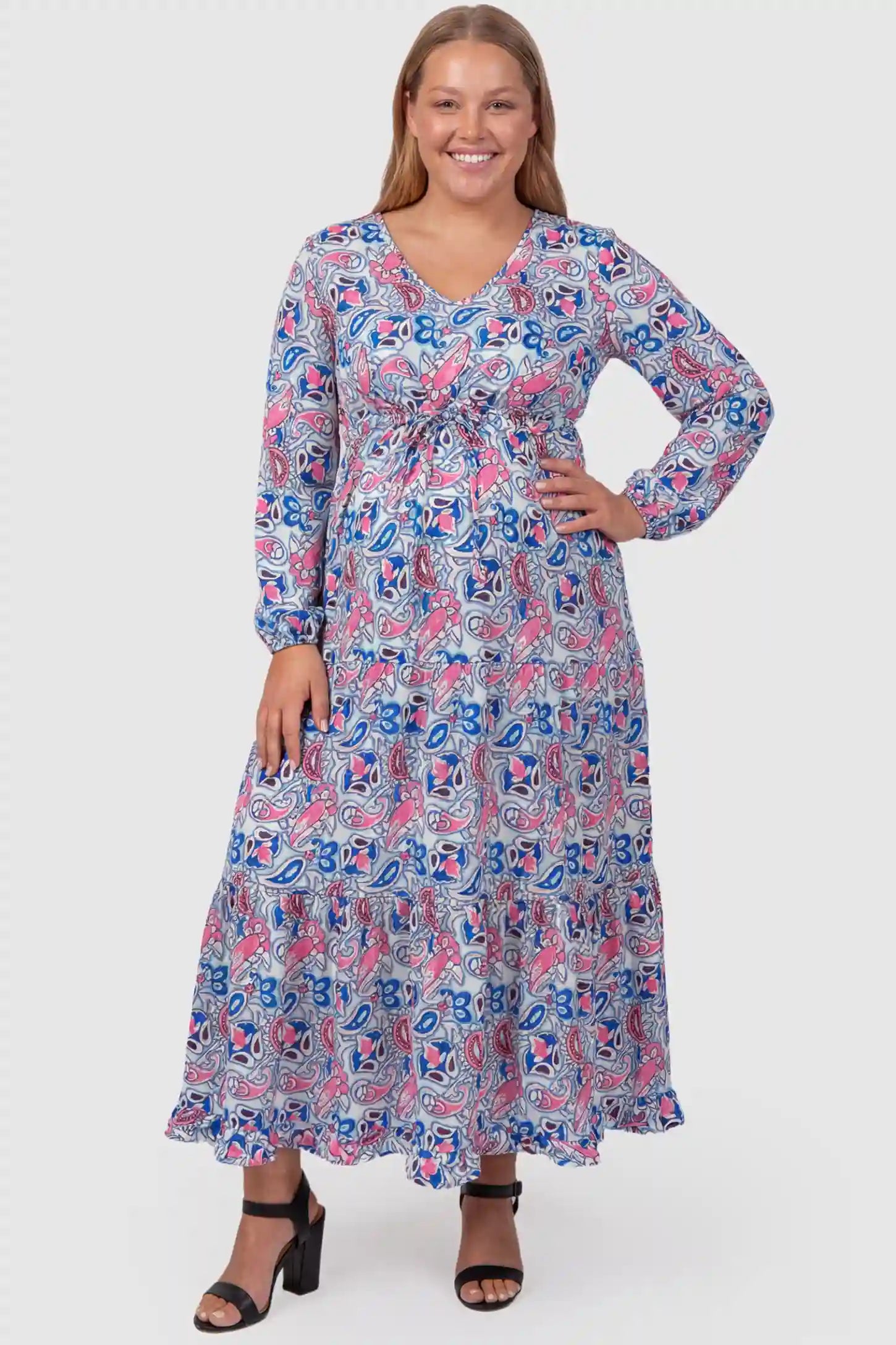 Paisley Print V-Neck Tiered Maternity Maxi Dress Paisley Print V-Neck Tiered Maternity Maxi Dress in peach red paisley pattern featuring empire waist and flowy tiered skirt on plus size pregnant model.