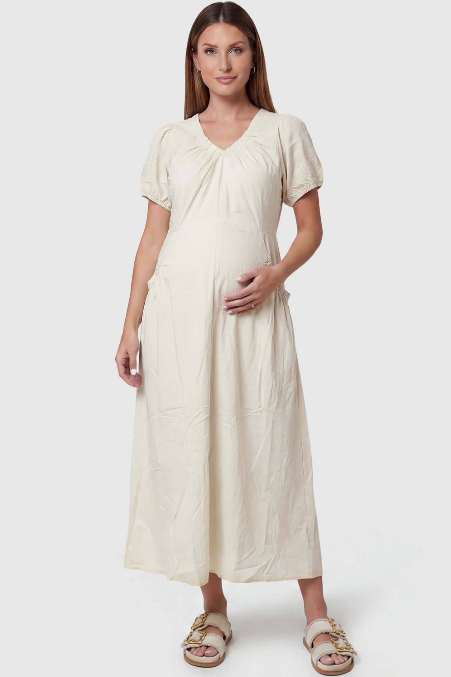 V-Neck Short Sleeve Maternity Midi Dress with Pockets V-neck short sleeve maternity midi dress with pockets in white with V-neckline detail, front view on pregnant model