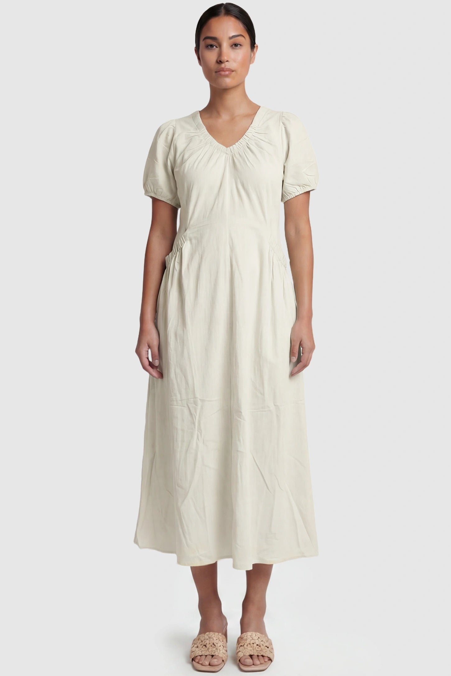 V-Neck Short Sleeve Maternity Midi Dress with Pockets V-neck short sleeve maternity midi dress with pockets in white with V-neckline detail, front view on postpartum model