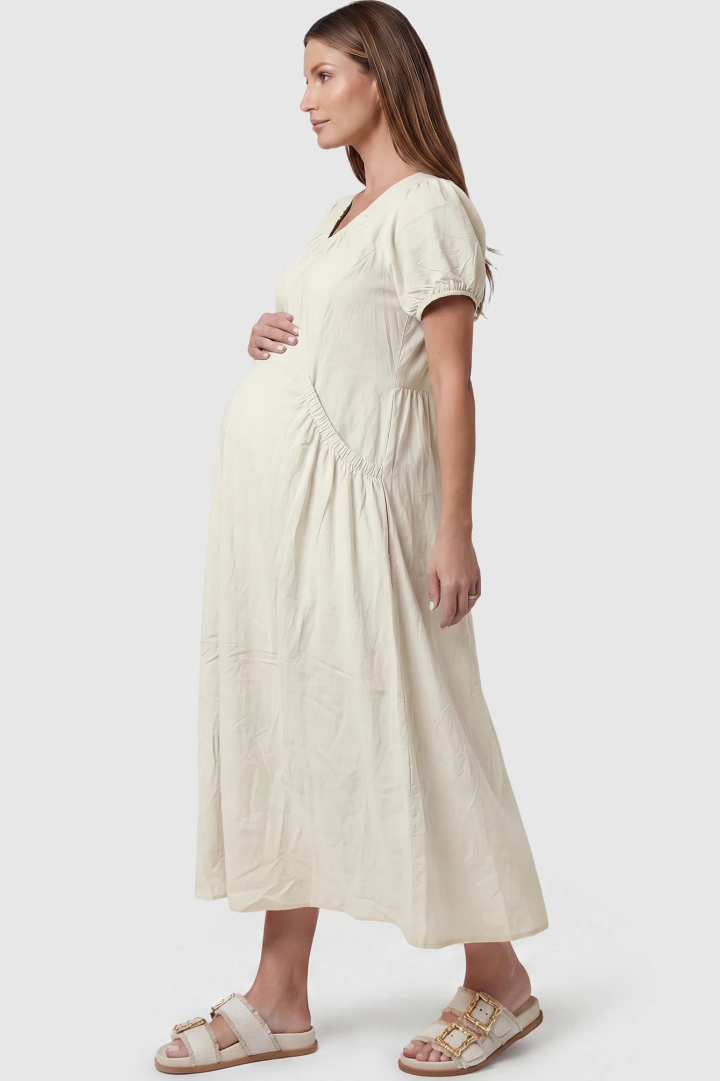 V-Neck Short Sleeve Maternity Midi Dress with Pockets V-neck short sleeve maternity midi dress with pockets in white with practical side pockets, side view on pregnant model