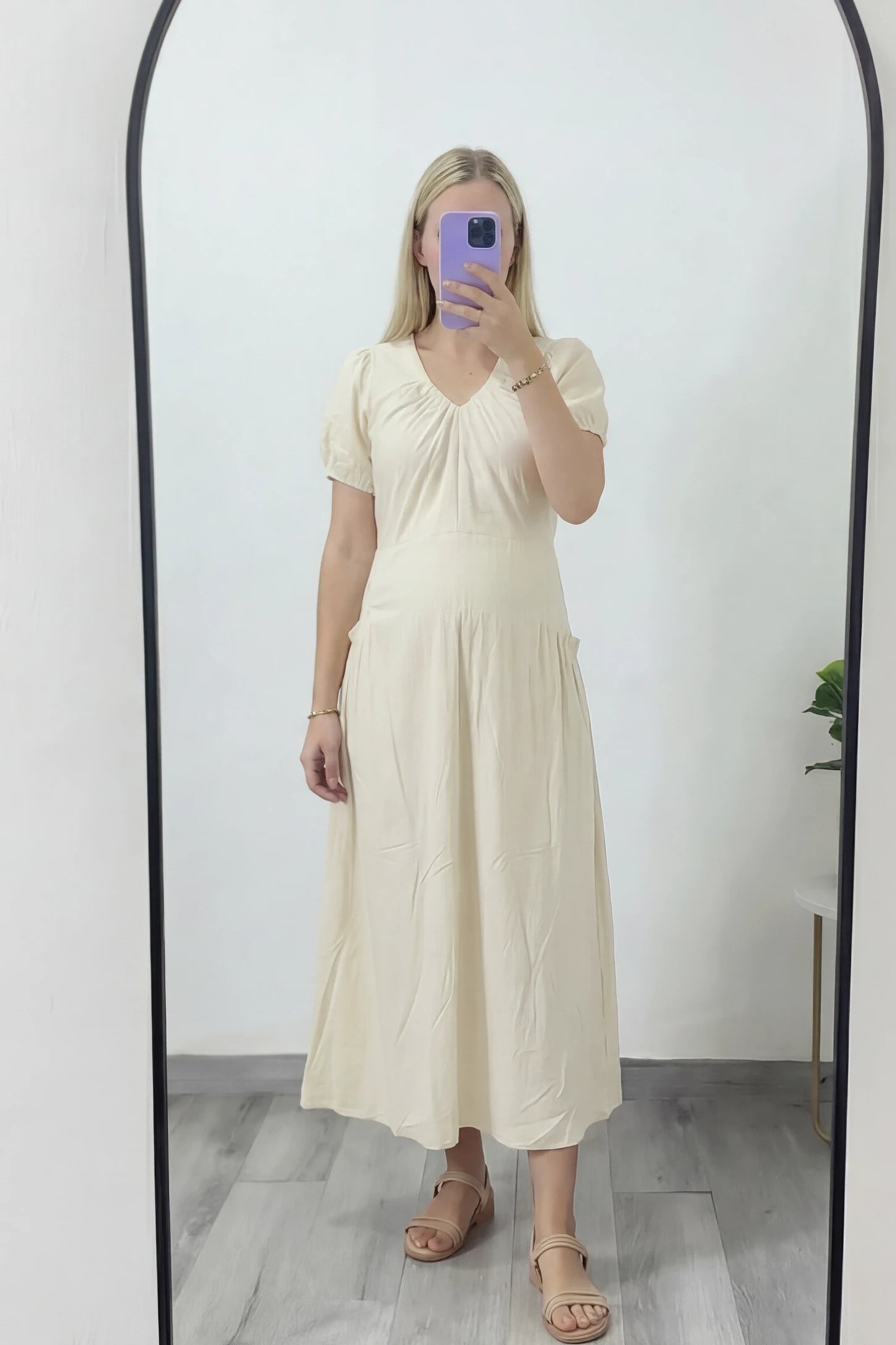 V-Neck Short Sleeve Maternity Midi Dress with Pockets V-neck short sleeve maternity midi dress with pockets in white with V-neckline detail, front view on pregnant model