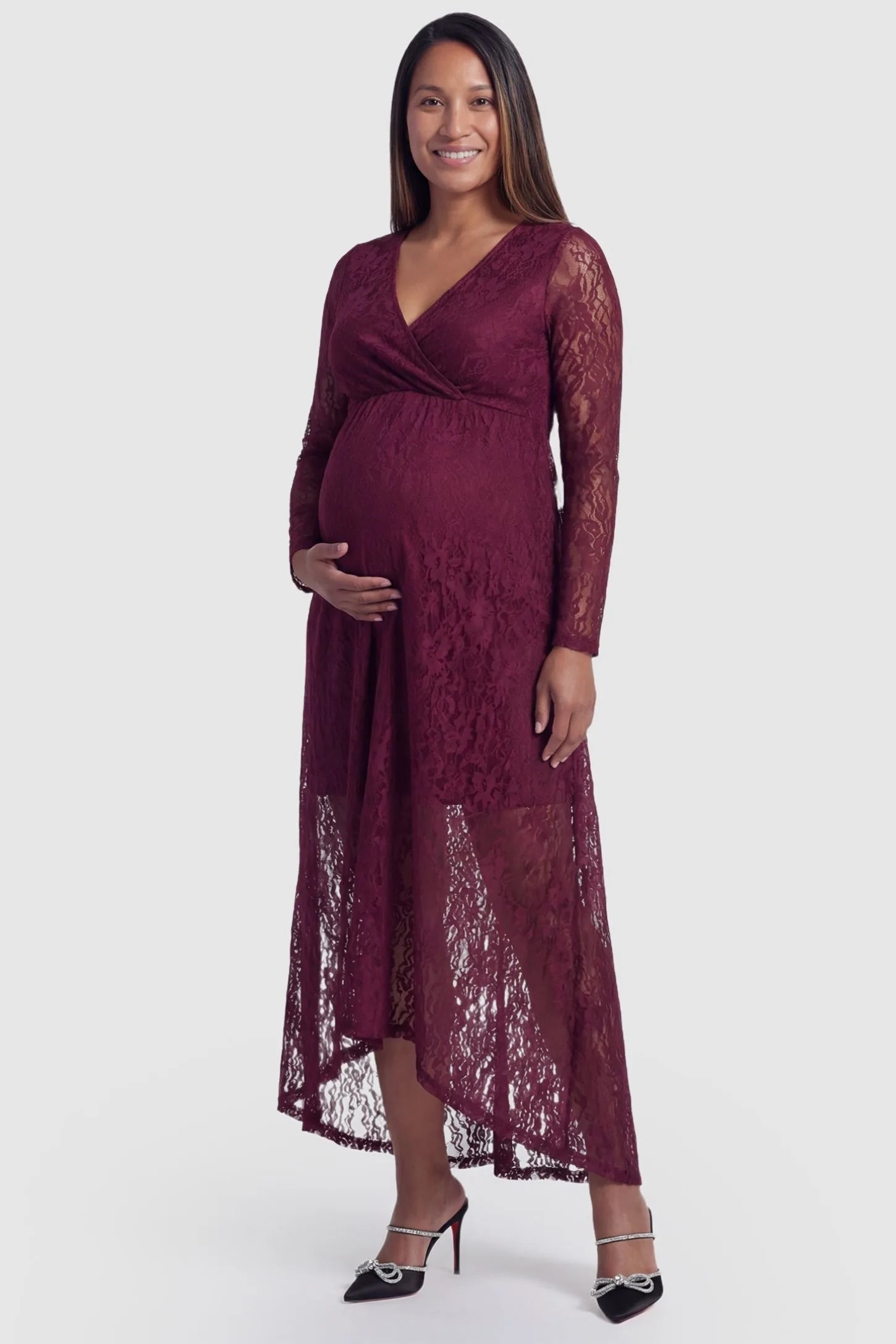 Hi-Low Hem Wrap Neck Maternity Midi Dress in wine red lace featuring long sleeves and empire waist on a pregnant model, front view
