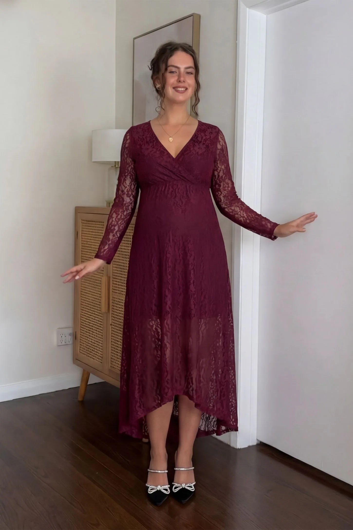 Hi-Low Hem Wrap Neck Maternity Midi Dress Hi-Low Hem Wrap Neck Maternity Midi Dress in wine red lace featuring long sleeves and empire waist on a pregnant model, front view