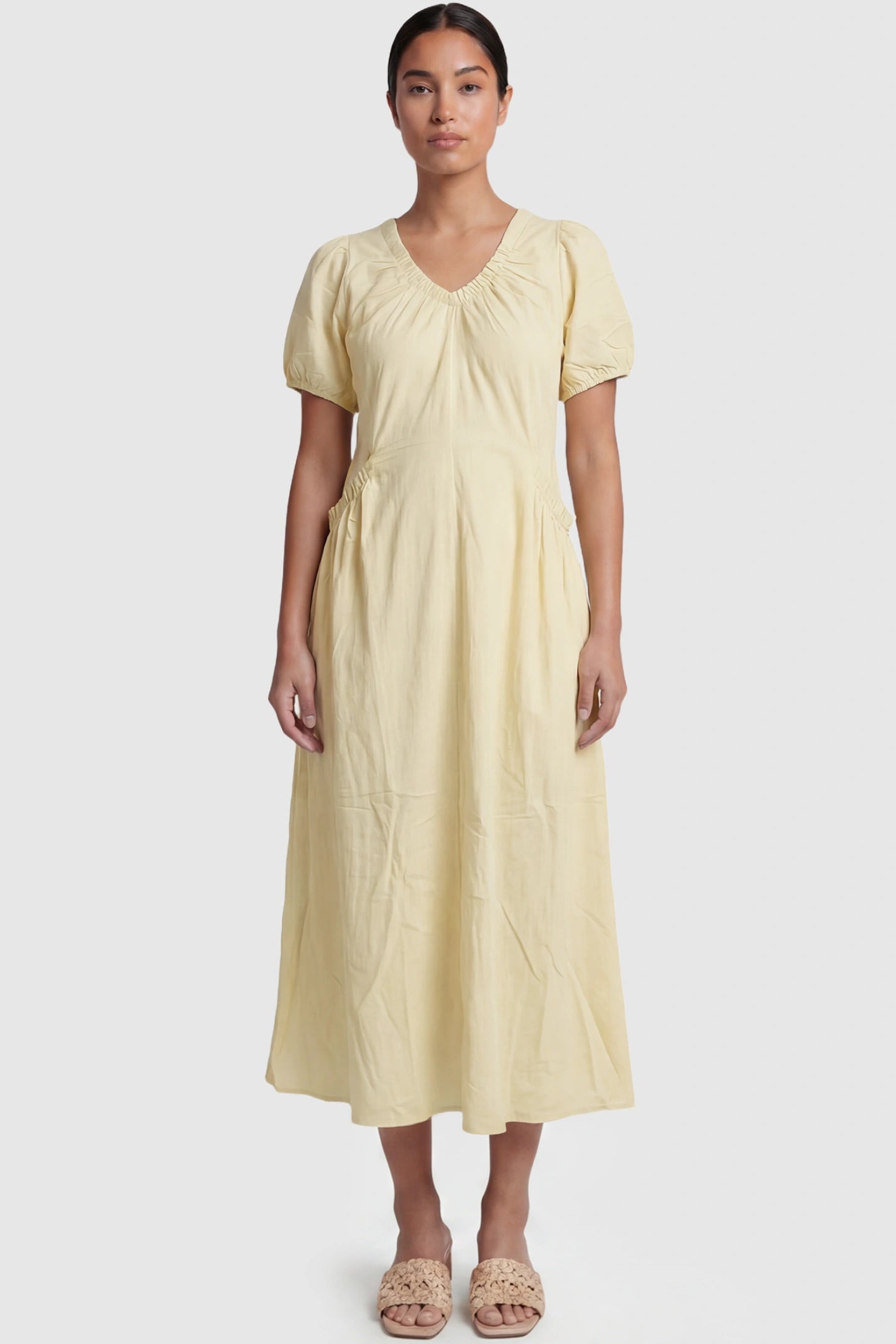 V-Neck Short Sleeve Maternity Midi Dress with Pockets V-neck short sleeve maternity midi dress with pockets in yellow with V-neckline detail, front view on postpartum model