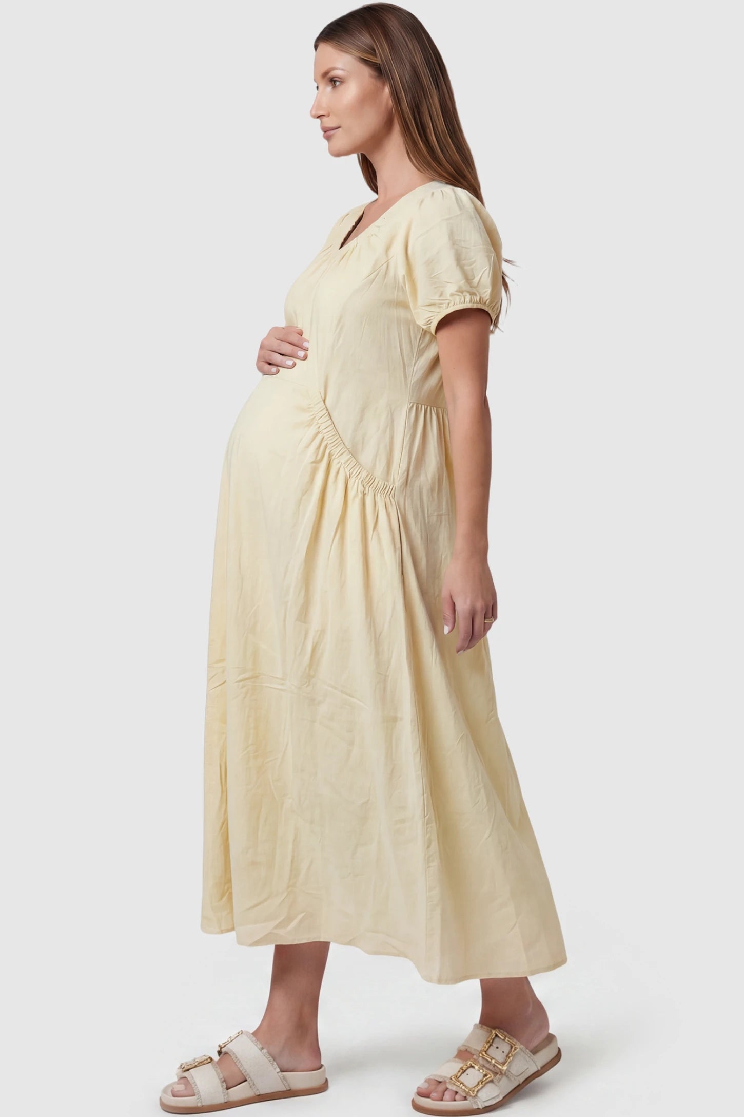 V-Neck Short Sleeve Maternity Midi Dress with Pockets V-neck short sleeve maternity midi dress with pockets in yellow with practical side pockets, side view on pregnant model