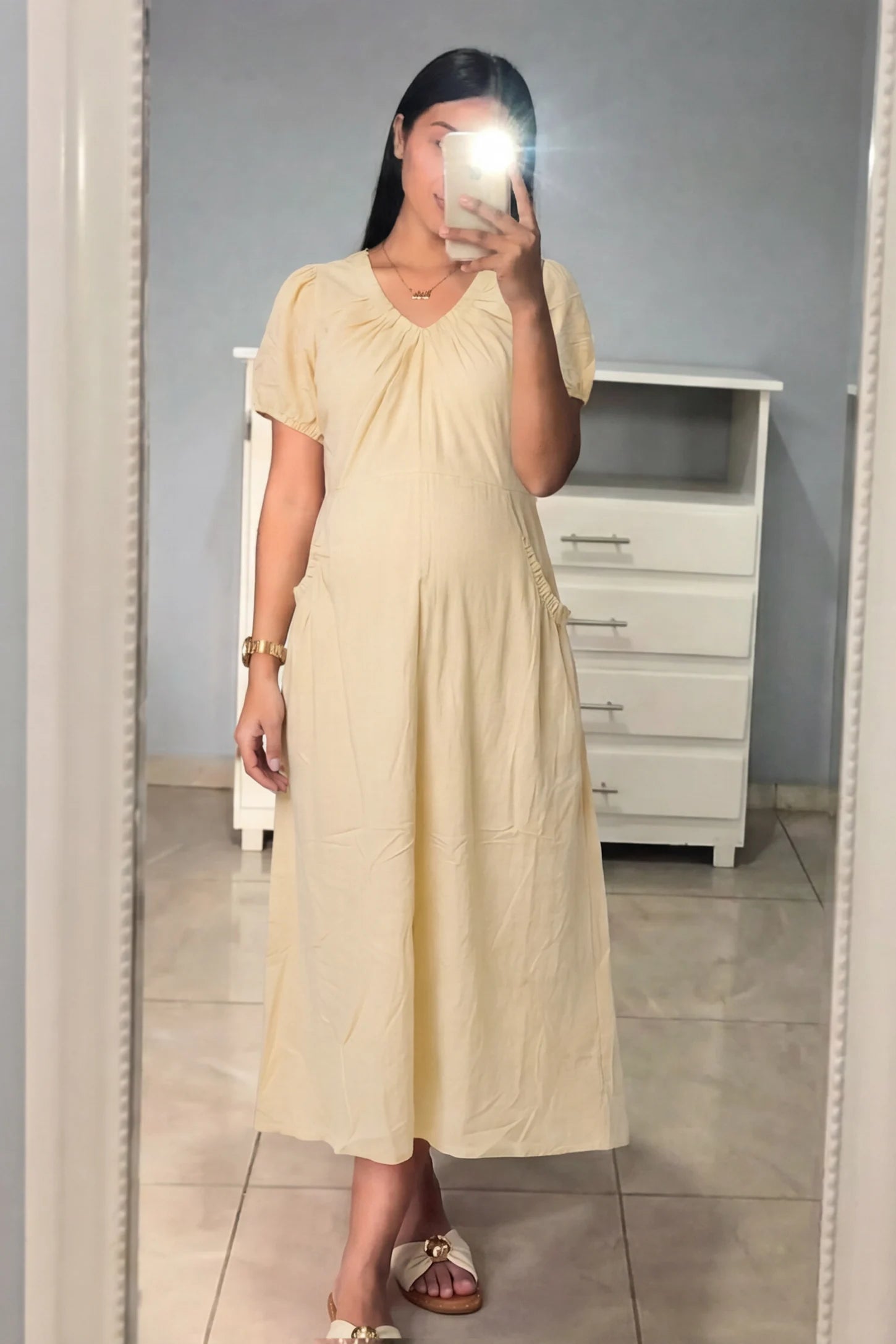 V-Neck Short Sleeve Maternity Midi Dress with Pockets V-neck short sleeve maternity midi dress with pockets in yellow with V-neckline detail, front view on pregnant model