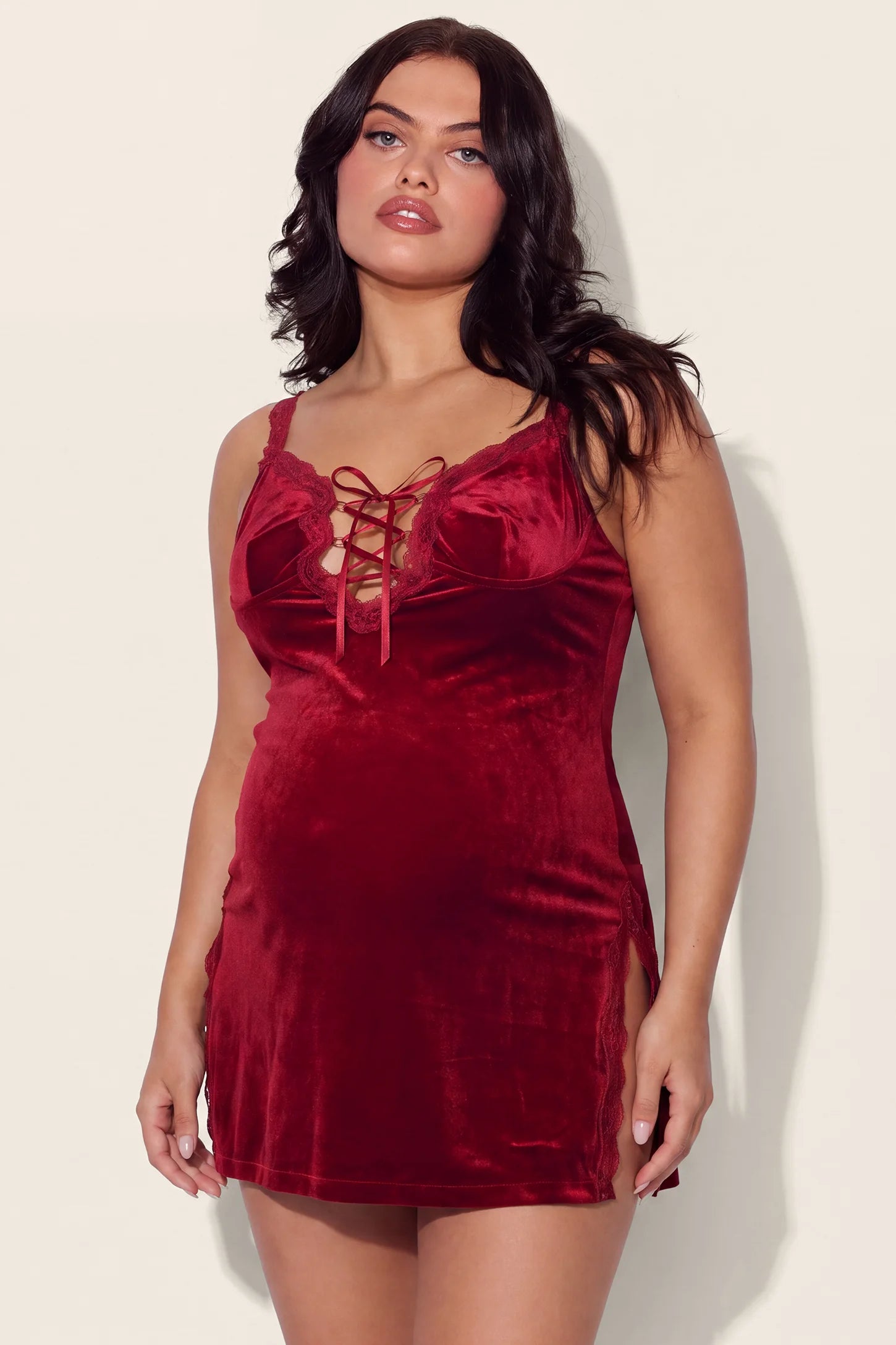 Velvet Lace Maternity Babydoll Nightgowns in Burgundy featuring a delicate lace-up front, high stretch lightweight velvet material, and comfortable v-neck silhouette on a pregnant model, front view.