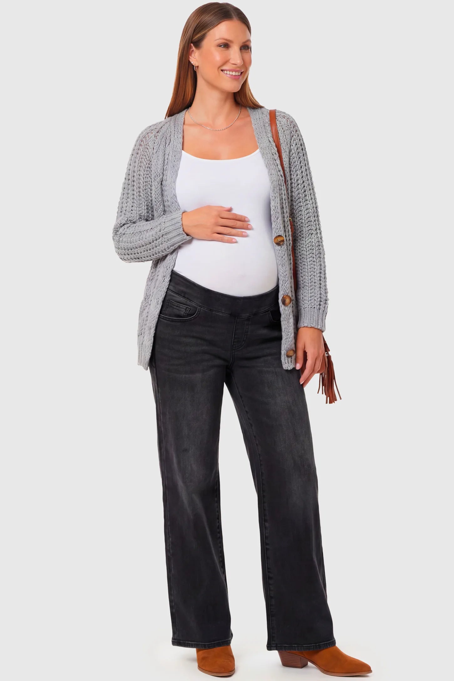 High-Rise Wide Leg Maternity Jeans High-Rise Wide Leg Maternity Jeans in black featuring over-the-belly support and wide-leg silhouette on a pregnant model.