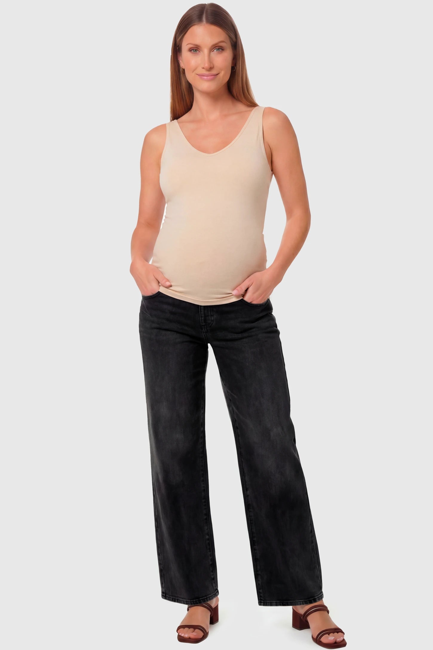 High-Rise Wide Leg Maternity Jeans High-Rise Wide Leg Maternity Jeans in black featuring over-the-belly support and wide-leg silhouette on a pregnant model.