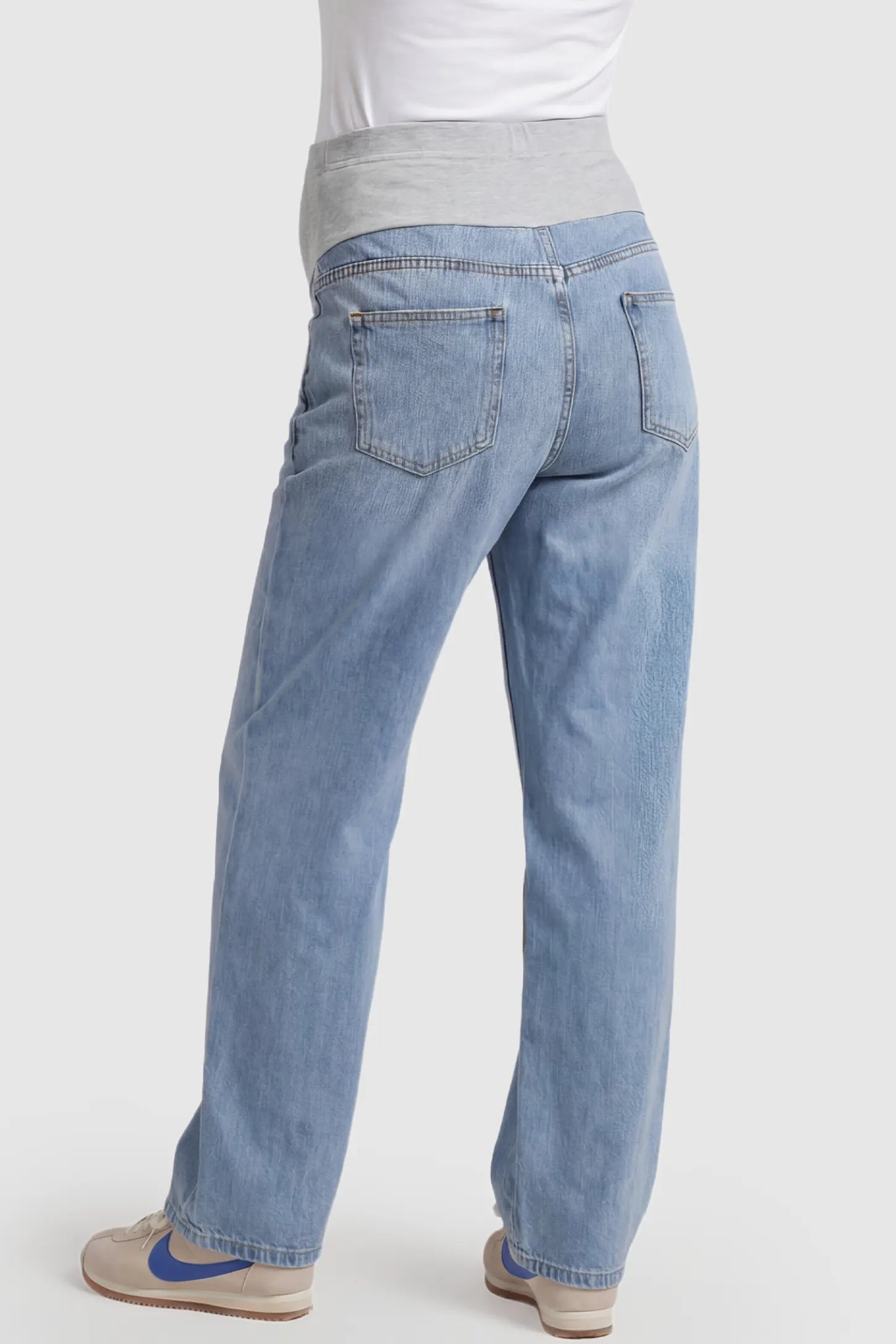 Denim Wide-Leg Maternity Jeans Denim straight-leg maternity jeans in light  blue wash featuring full belly panel support and relaxed fit on pregnant model.