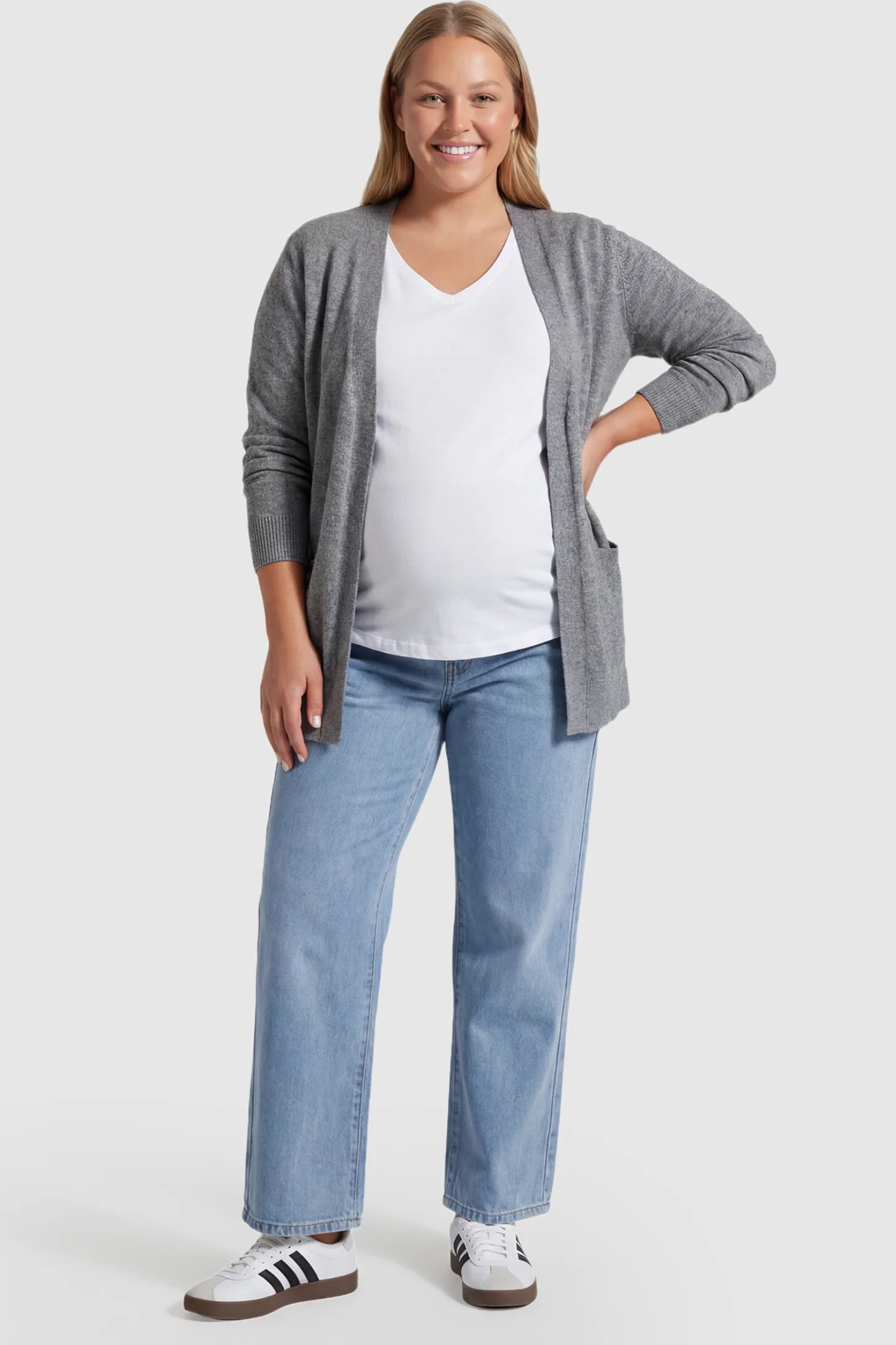 Denim Wide-Leg Maternity Jeans Denim straight-leg maternity jeans in light  blue wash featuring full belly panel support and relaxed fit on plus size pregnant model.