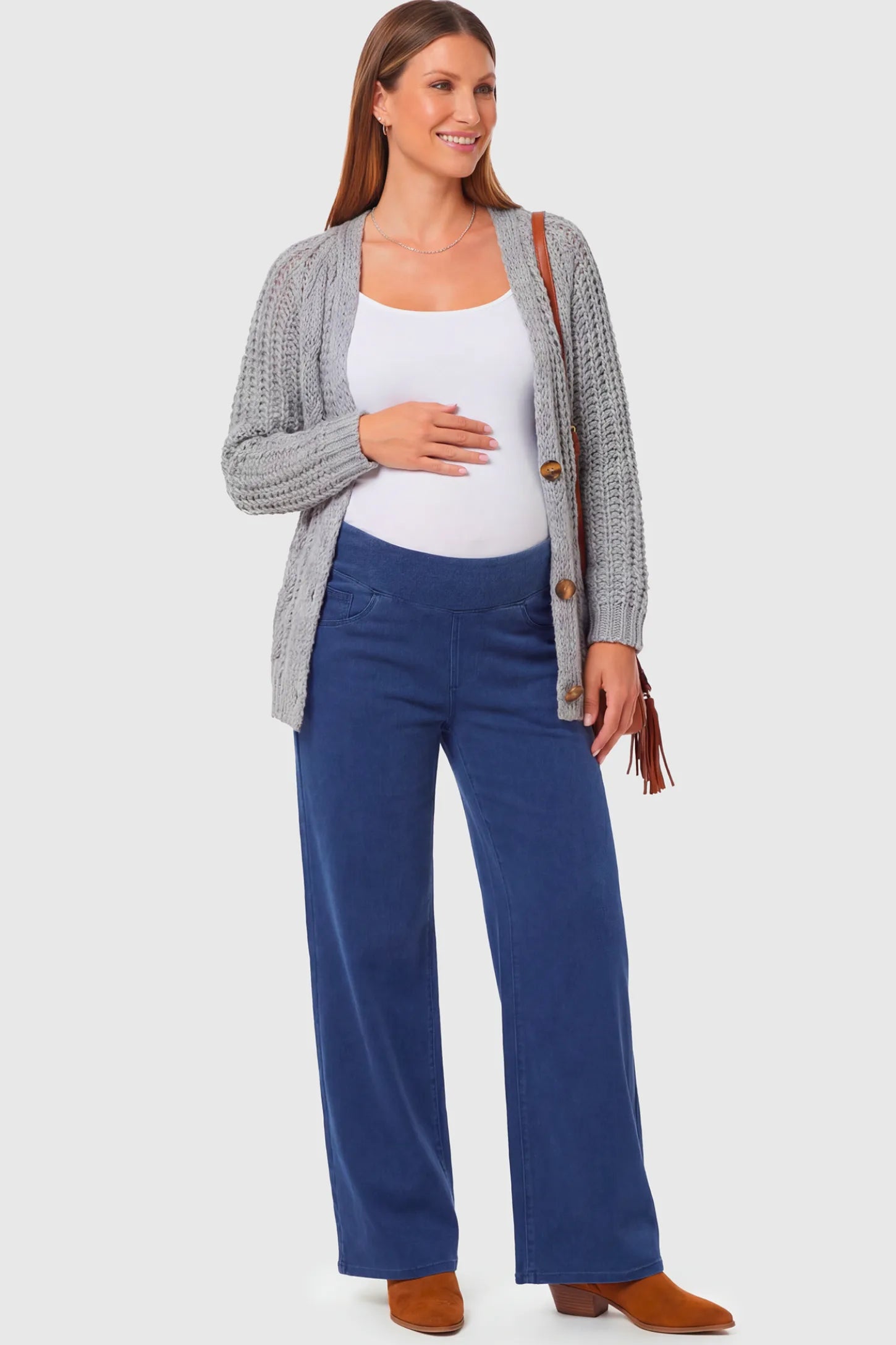 High-Rise Wide Leg Maternity Jeans High-Rise Wide Leg Maternity Jeans in dark blue featuring over-the-belly support and wide-leg silhouette on a pregnant model.