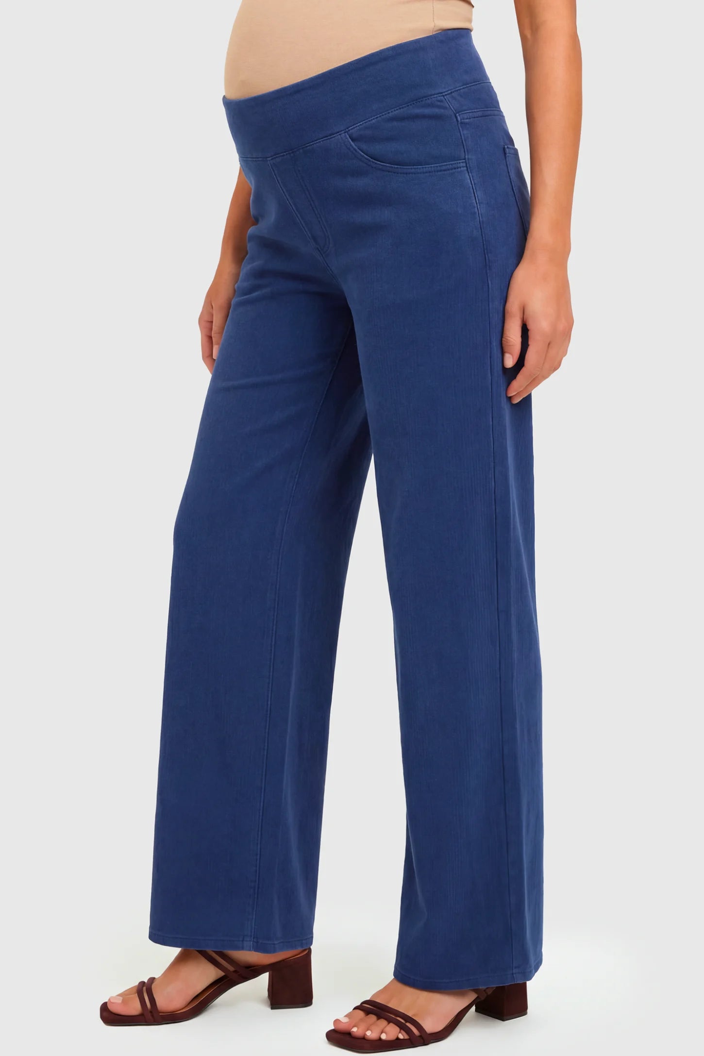 High-Rise Wide Leg Maternity Jeans High-Rise Wide Leg Maternity Jeans in dark blue featuring over-the-belly support and wide-leg silhouette on a pregnant model.