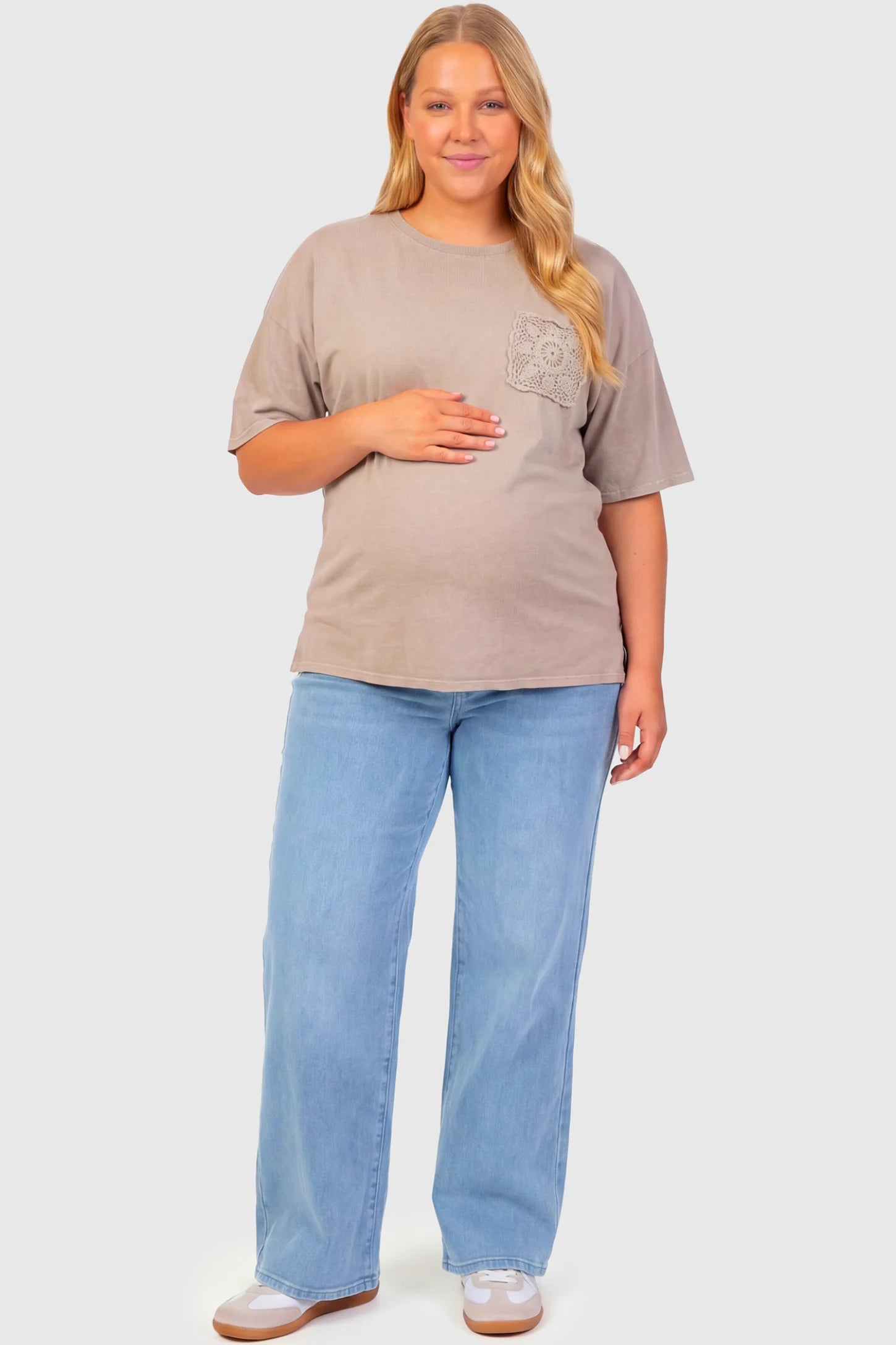 High-Rise Wide Leg Maternity Jeans High-Rise Wide Leg Maternity Jeans in light blue  featuring over-the-belly support and wide-leg silhouette on a plus size pregnant model.