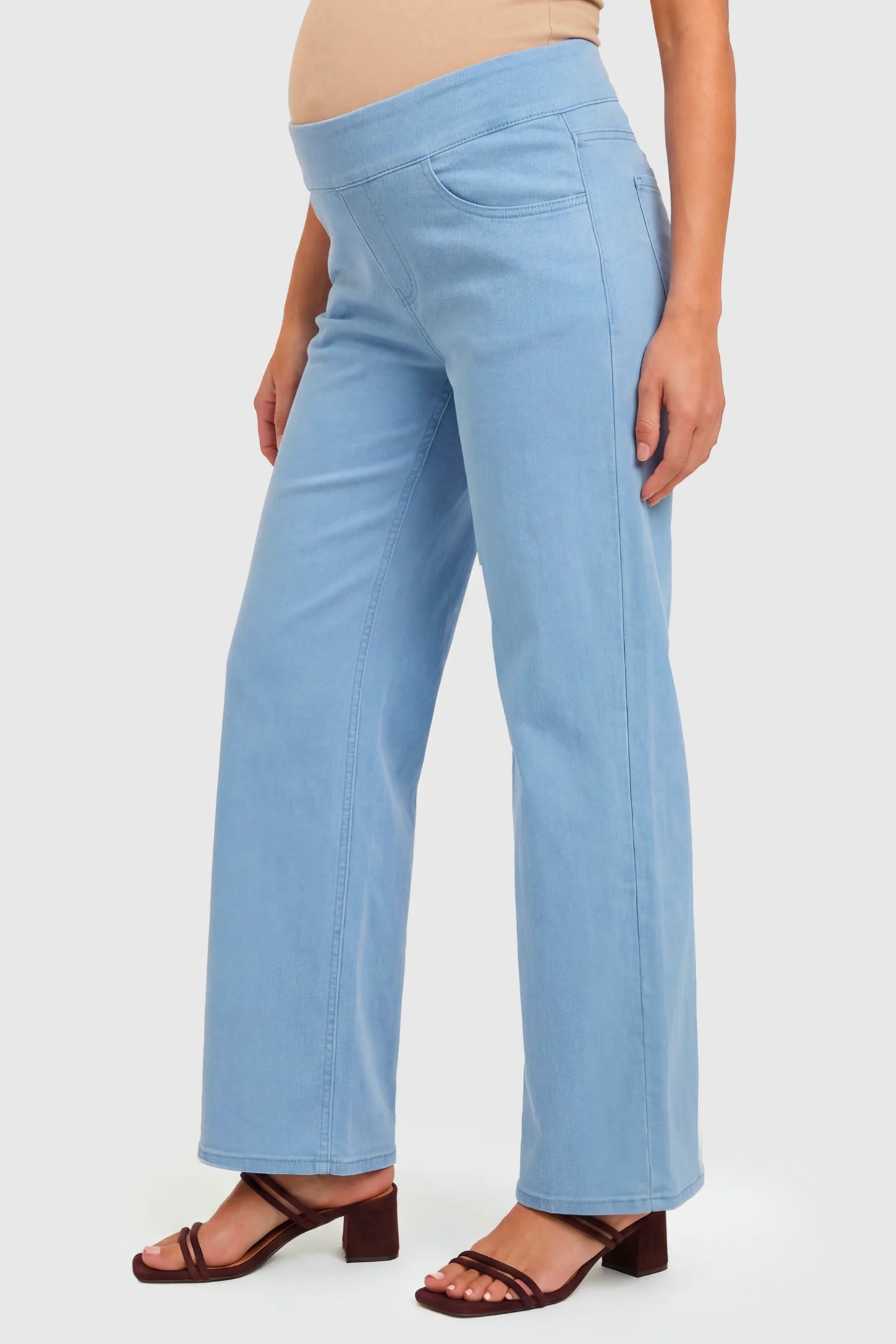 High-Rise Wide Leg Maternity Jeans High-Rise Wide Leg Maternity Jeans in light blue  featuring over-the-belly support and wide-leg silhouette on a pregnant model.