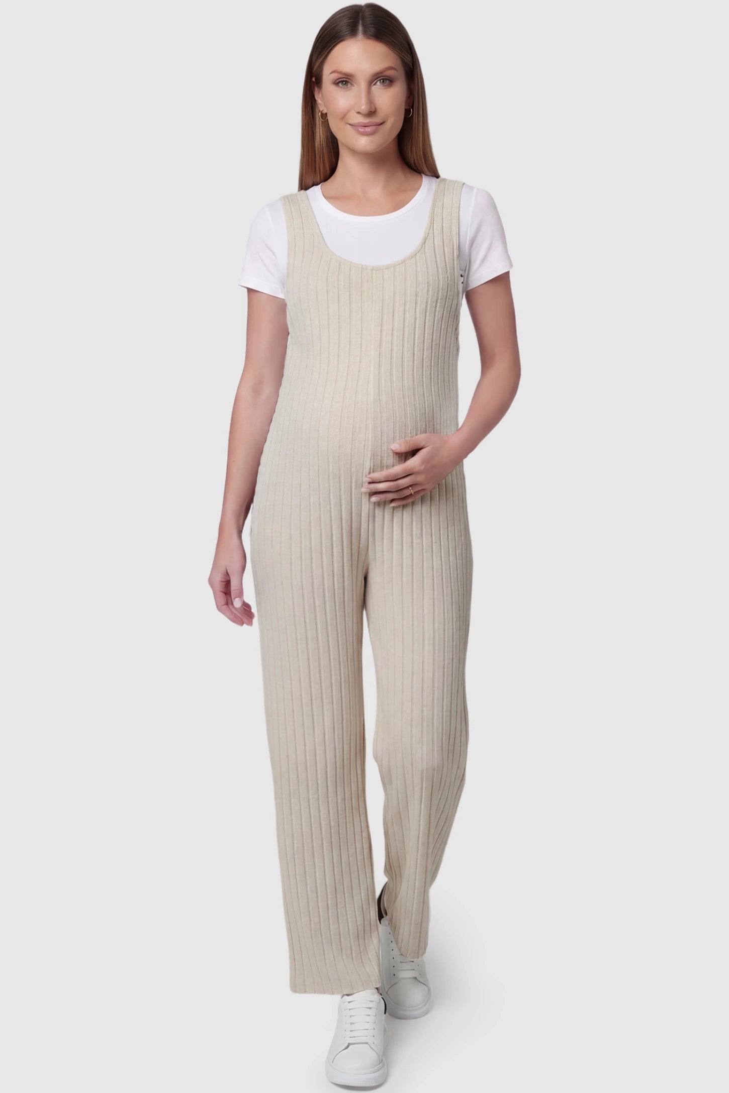 Ribbed Sleeveless Wide-Leg Maternity Jumpsuit Ribbed sleeveless wide-leg maternity jumpsuit in apricot with sleeveless ribbed design, front view on pregnant model