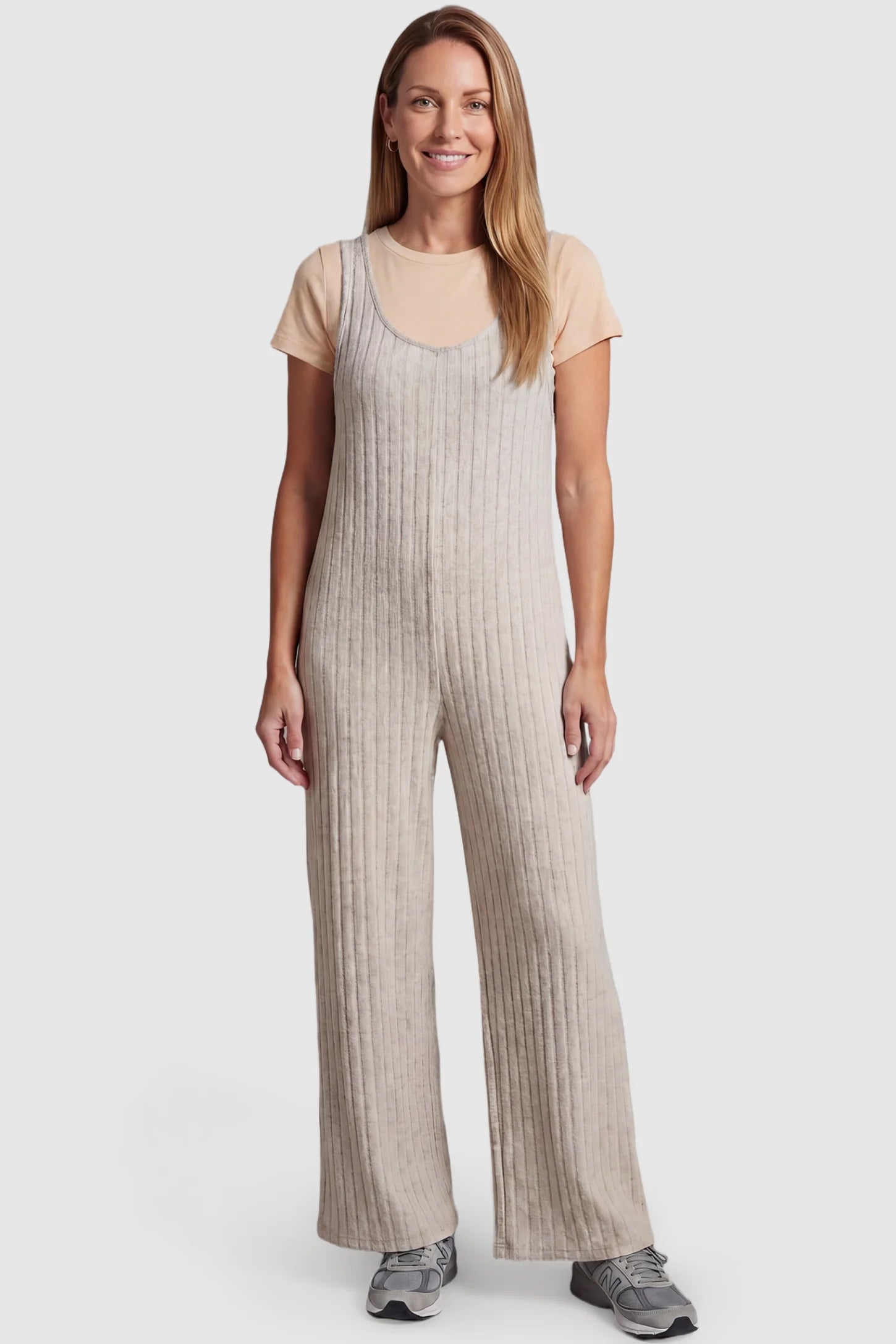 Ribbed Sleeveless Wide-Leg Maternity Jumpsuit Ribbed sleeveless wide-leg maternity jumpsuit in apricot with sleeveless ribbed design, front view on postpartum model