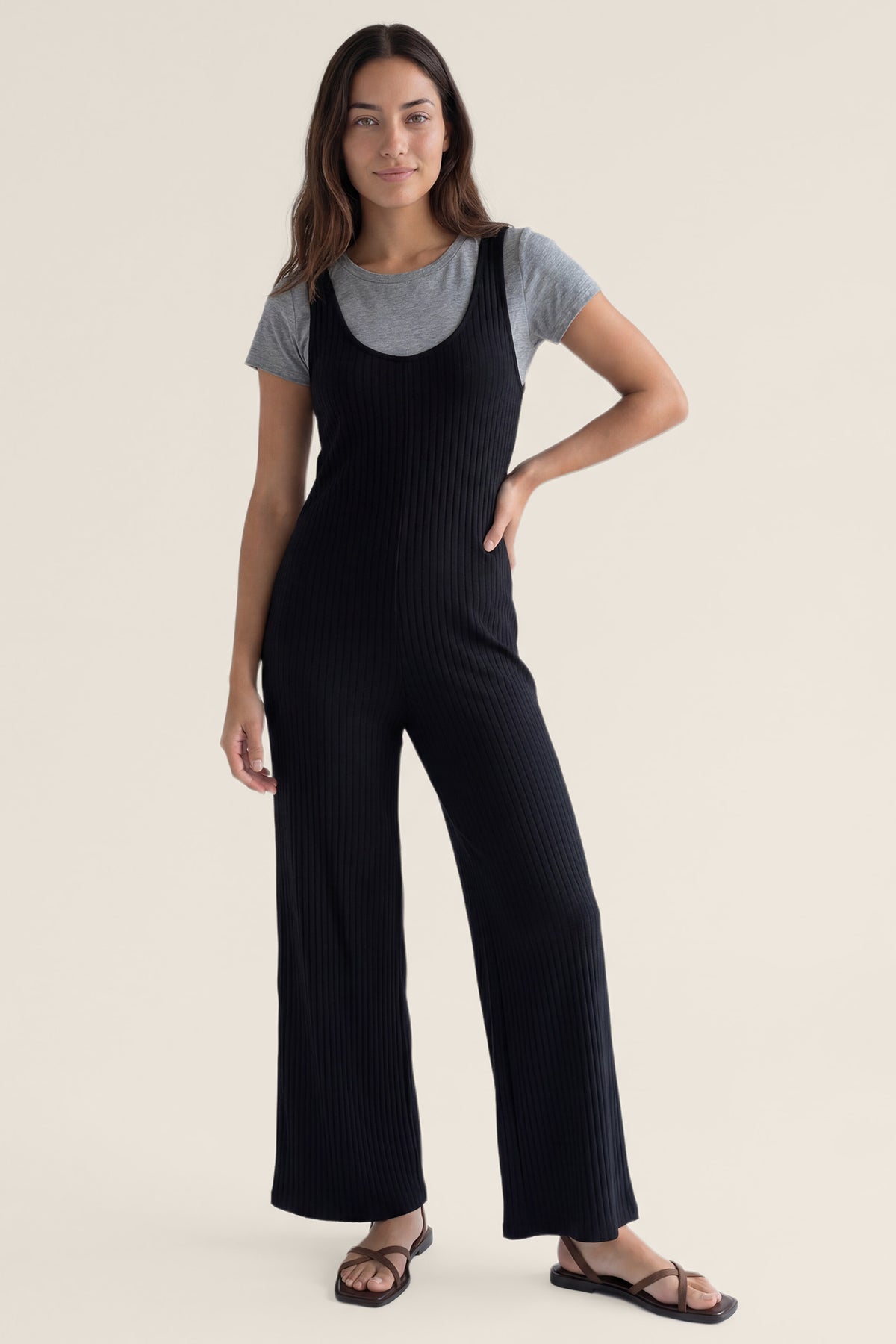 Ribbed Sleeveless Wide-Leg Maternity Jumpsuit Ribbed sleeveless wide-leg maternity jumpsuit in black with sleeveless ribbed design, front view on postpartum model
