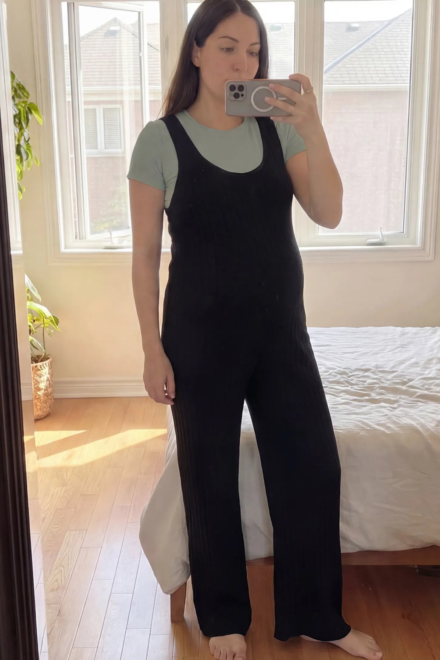 Ribbed Sleeveless Wide-Leg Maternity Jumpsuit Ribbed sleeveless wide-leg maternity jumpsuit in black with sleeveless ribbed design, front view on pregnant model