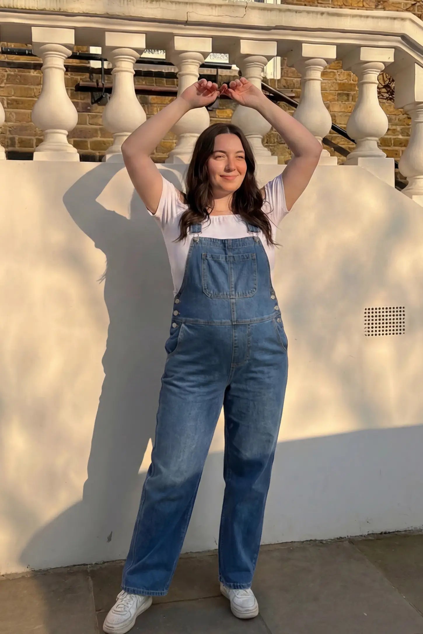 Wide Leg Relaxed Fit Maternity Overalls Wide leg relaxed fit maternity overalls in blue with adjustable straps and front pockets, front view on pregnant model