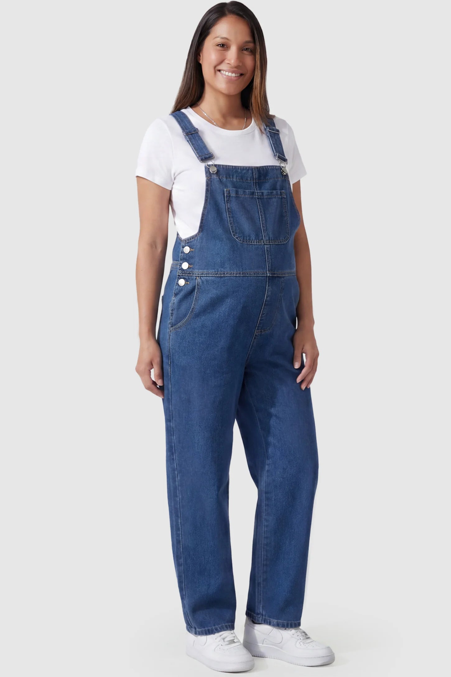 Wide Leg Relaxed Fit Maternity Overalls Wide leg relaxed fit maternity overalls in blue with adjustable straps and front pockets, front view on pregnant model