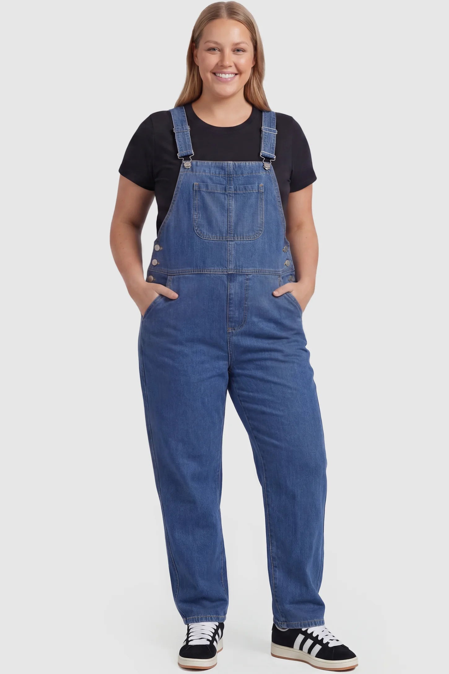 Wide Leg Relaxed Fit Maternity Overalls Wide leg relaxed fit maternity overalls in blue with adjustable straps and front pockets, front view on plus-size model