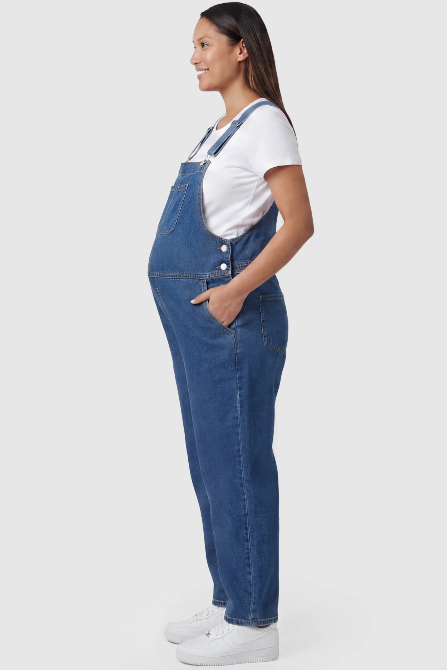 Wide Leg Relaxed Fit Maternity Overalls Wide leg relaxed fit maternity overalls in blue with side pockets, side view on pregnant model